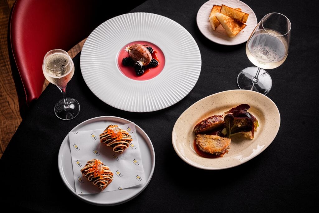 TOKI tasting menu spread with sushi bites berry dessert crumbed dish and champagne glasses Miller Street North Sydney
