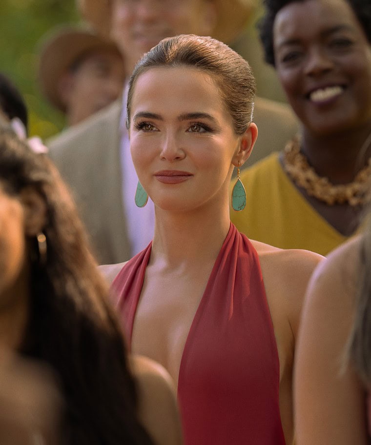 Voicemails for Isabelle Netflix film character in red halter dress with turquoise earrings at outdoor gathering