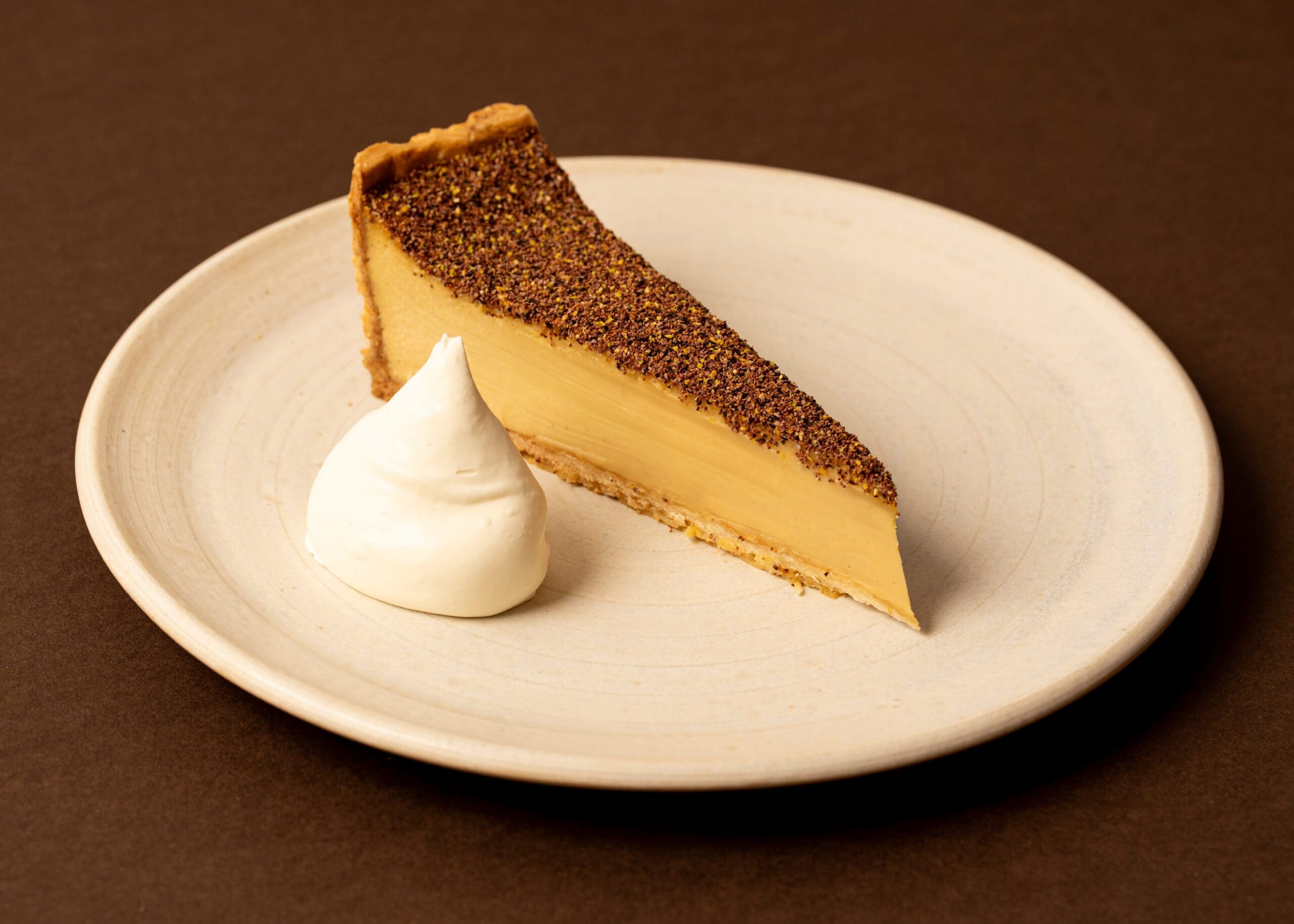 Wattleseed custard tart with whipped cream at Arthur Surry Hills Sydney