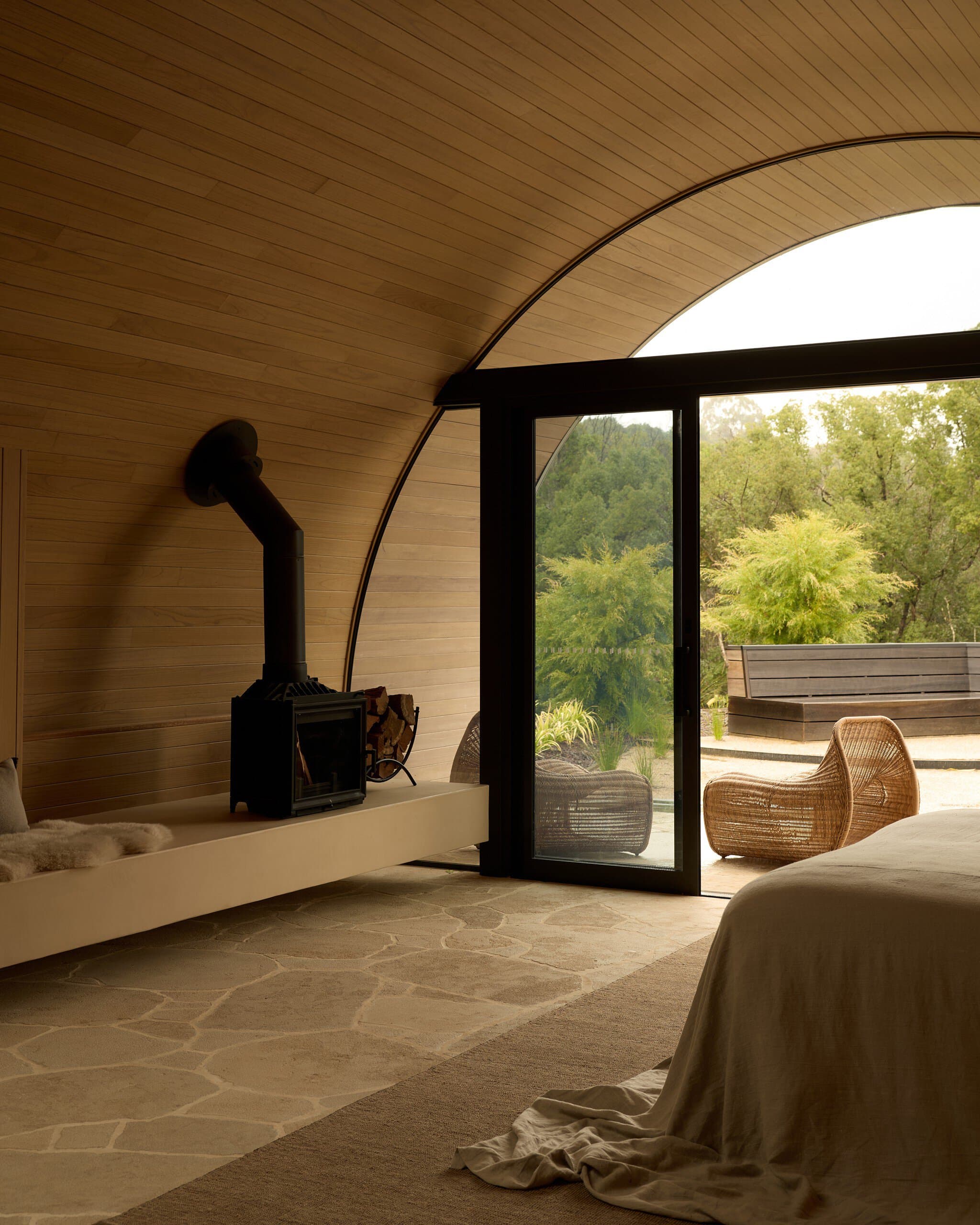 Bedroom with wood fireplace and courtyard doors at Temple Hangars Nashua NSW