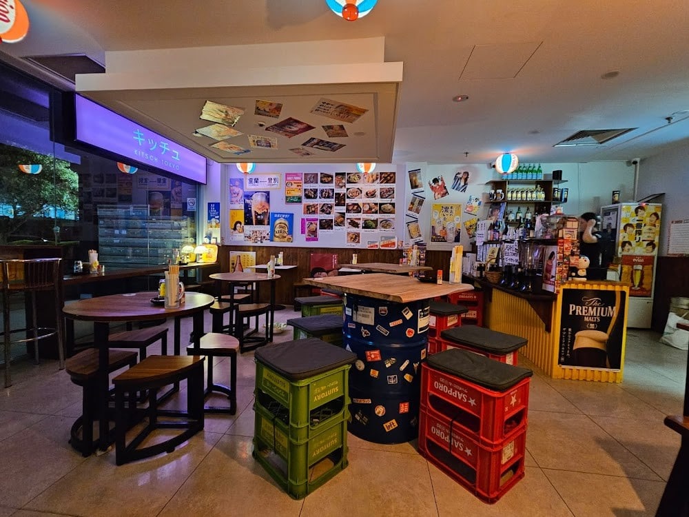 Yakitori Bar Kitsch Tokyo dining room with Suntory crate stools beer barrel tables and Japanese poster wall Chatswood Sydney