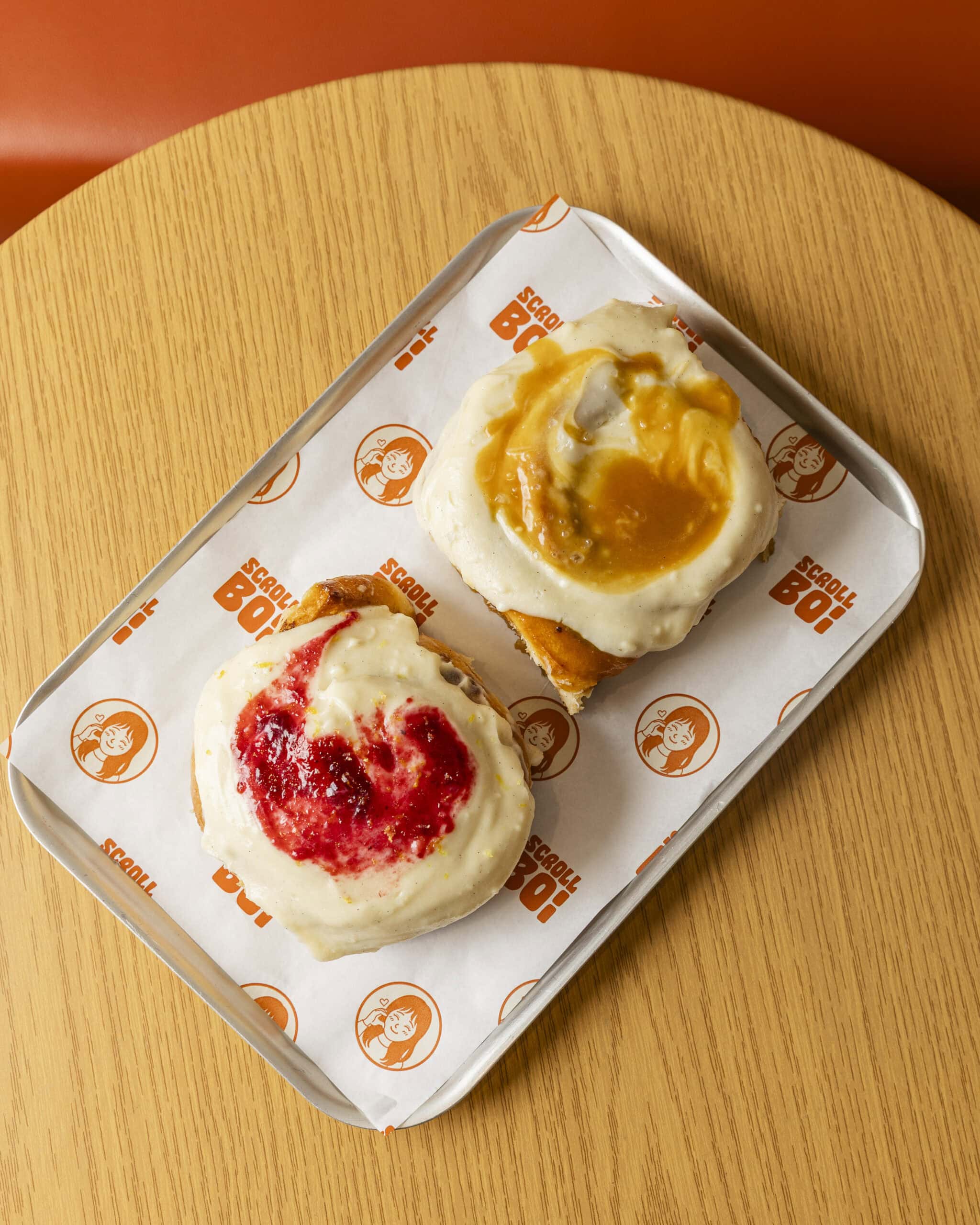 Yuzu and blackberry scroll and cream cheese scroll on tray at Scroll Boi Kingsgrove Sydney