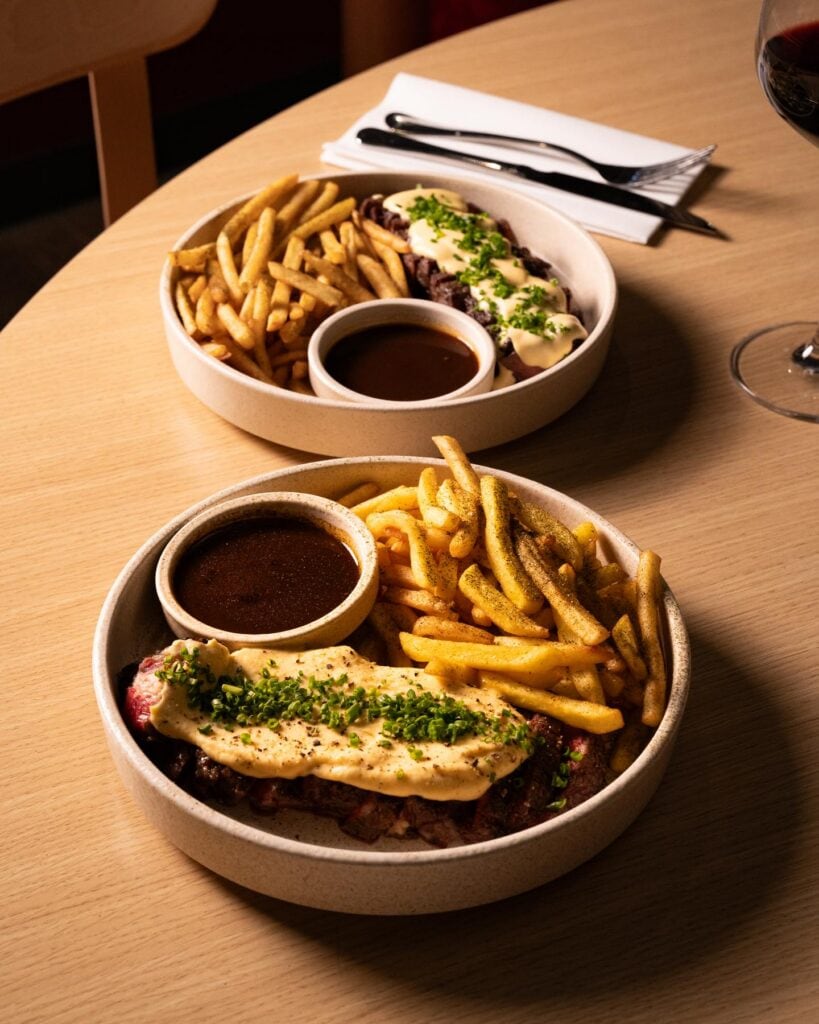 Two identical main dishes of steak and fries at Koyo in Adelaide
