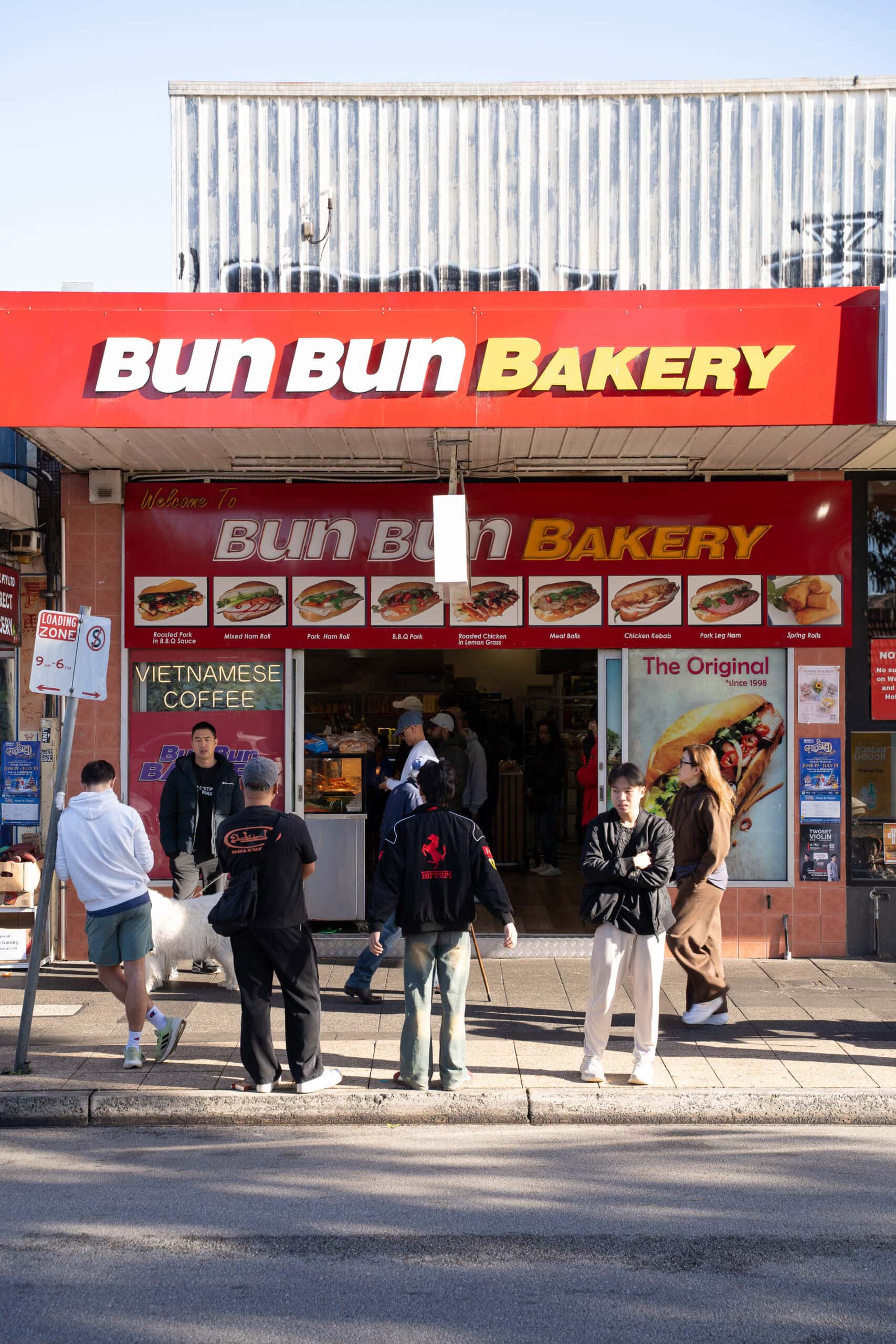 Front entrance of Bun Bun Bakery in Springvale with customers waiting outside.