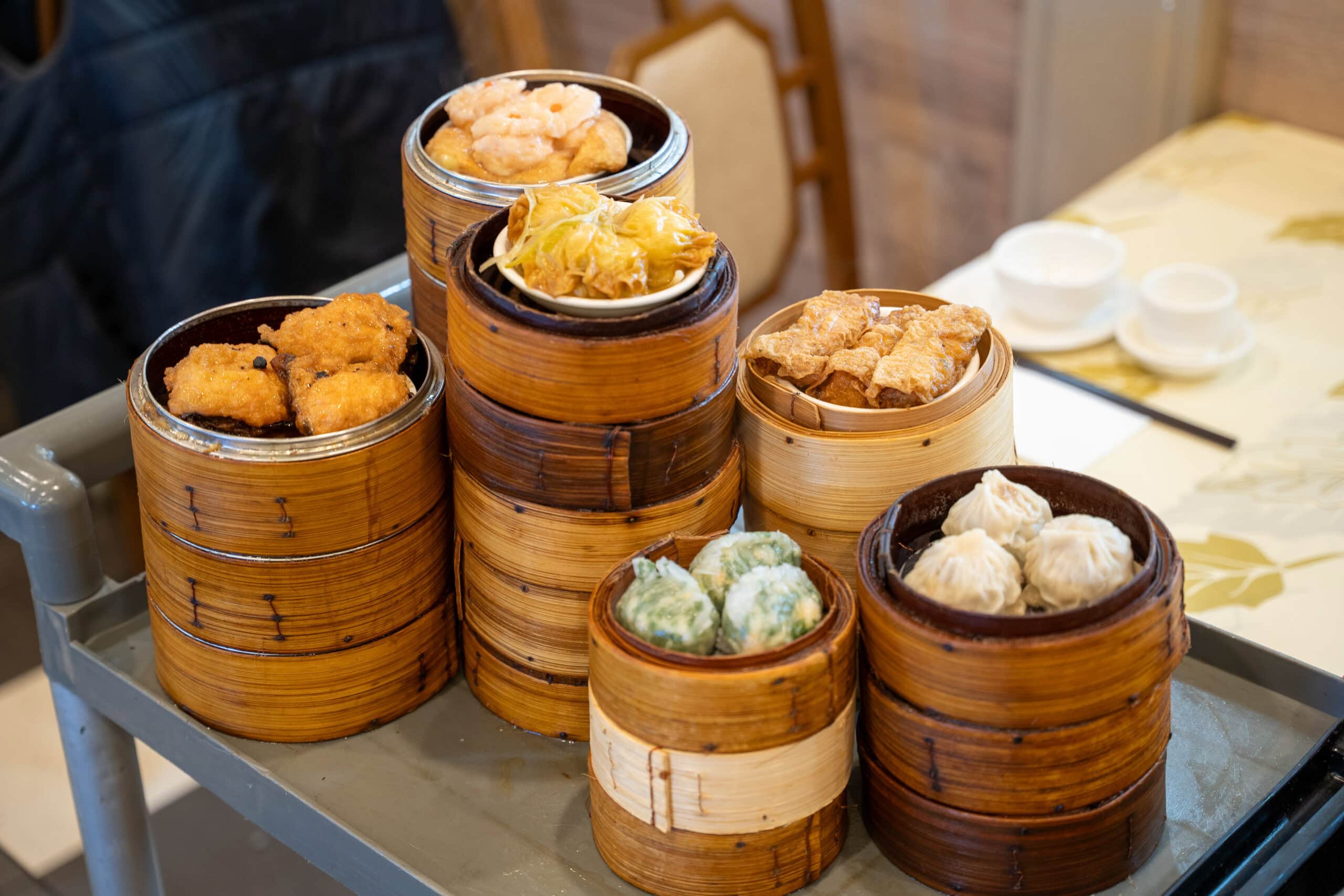 Assorted dim sum in bamboo steamers on a service trolley at Gold Leaf Restaurant.
