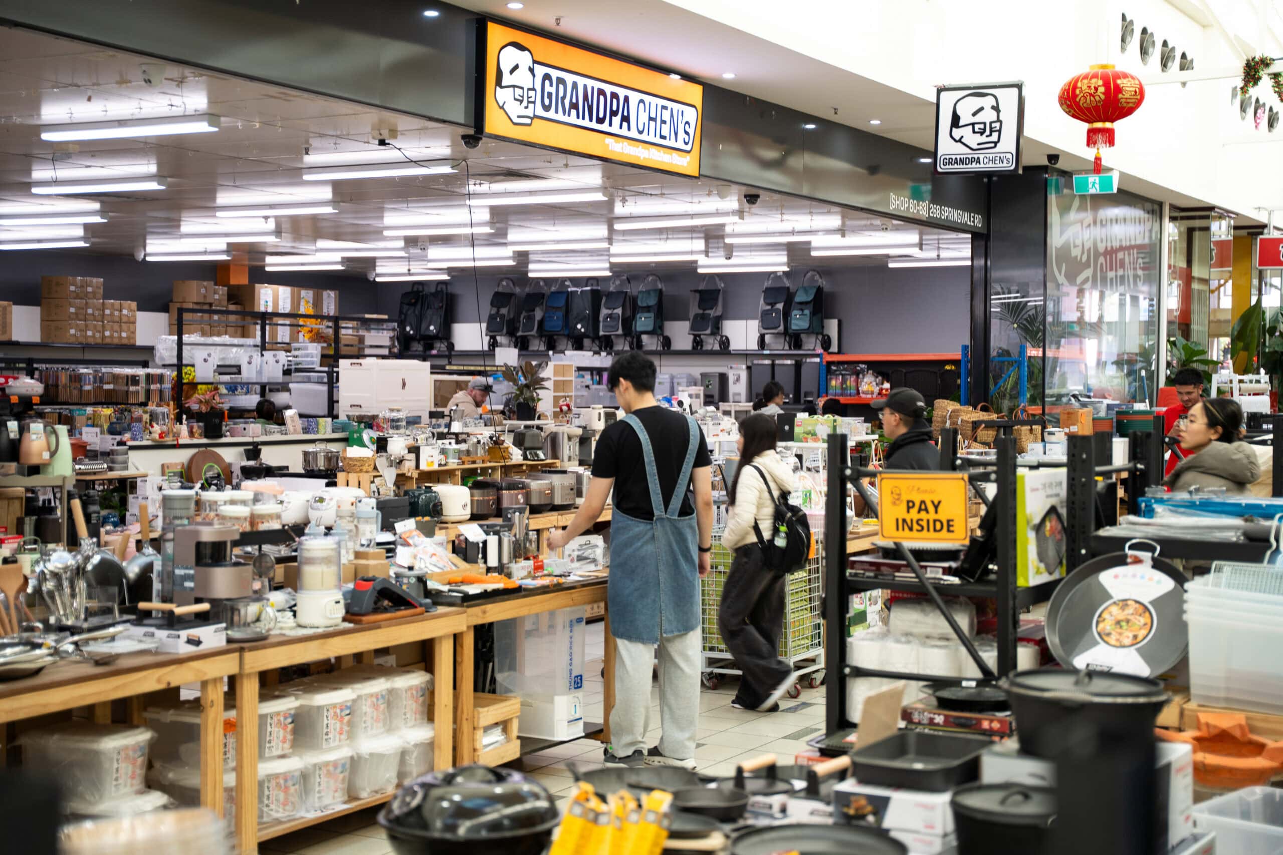 Entrance to Grandpa Chen's kitchenware store in Springvale with shoppers browsing inside.