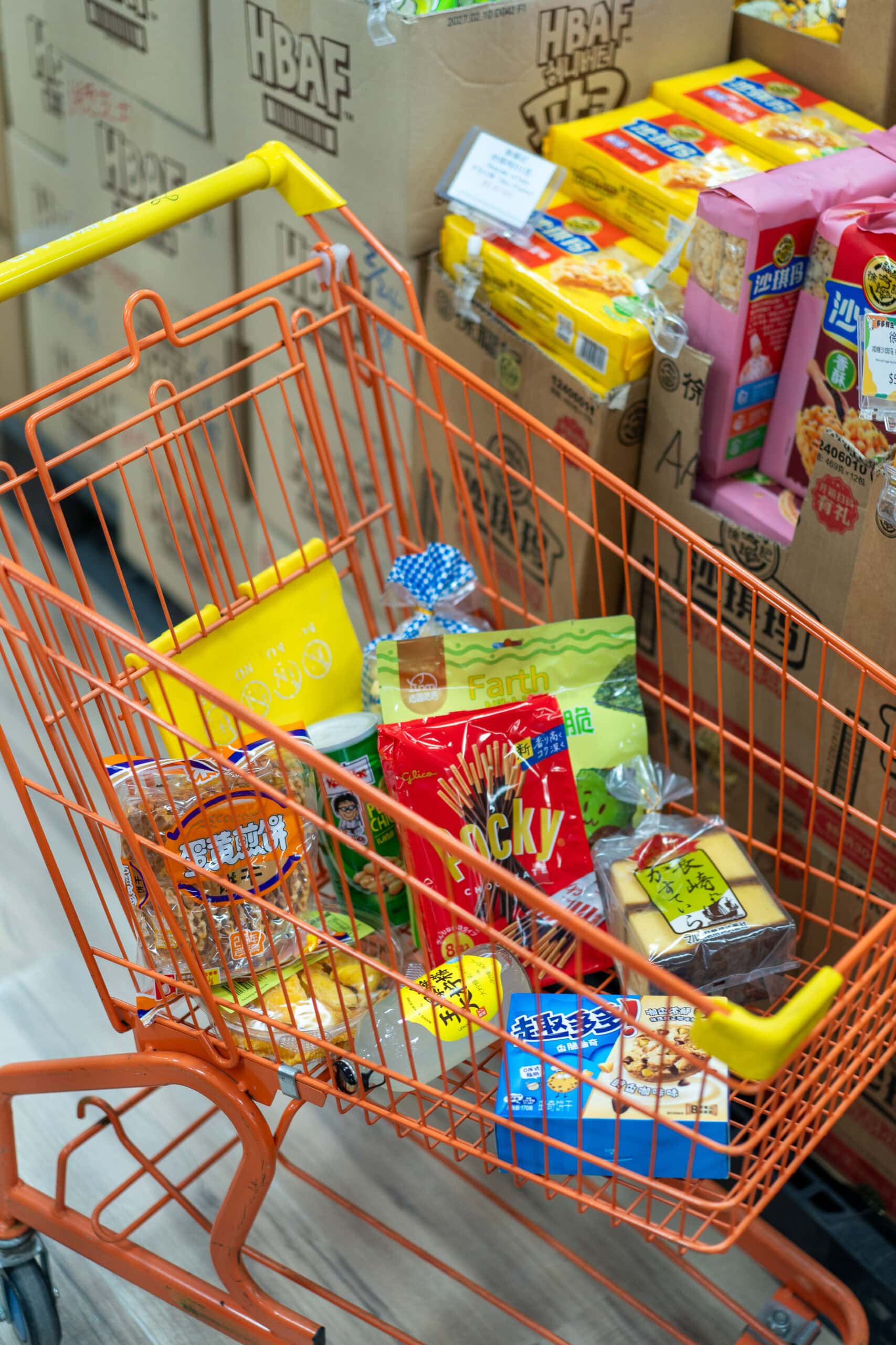 Shopping trolley filled with imported snacks and groceries at Mr Dodo Wholesale Supermarket.