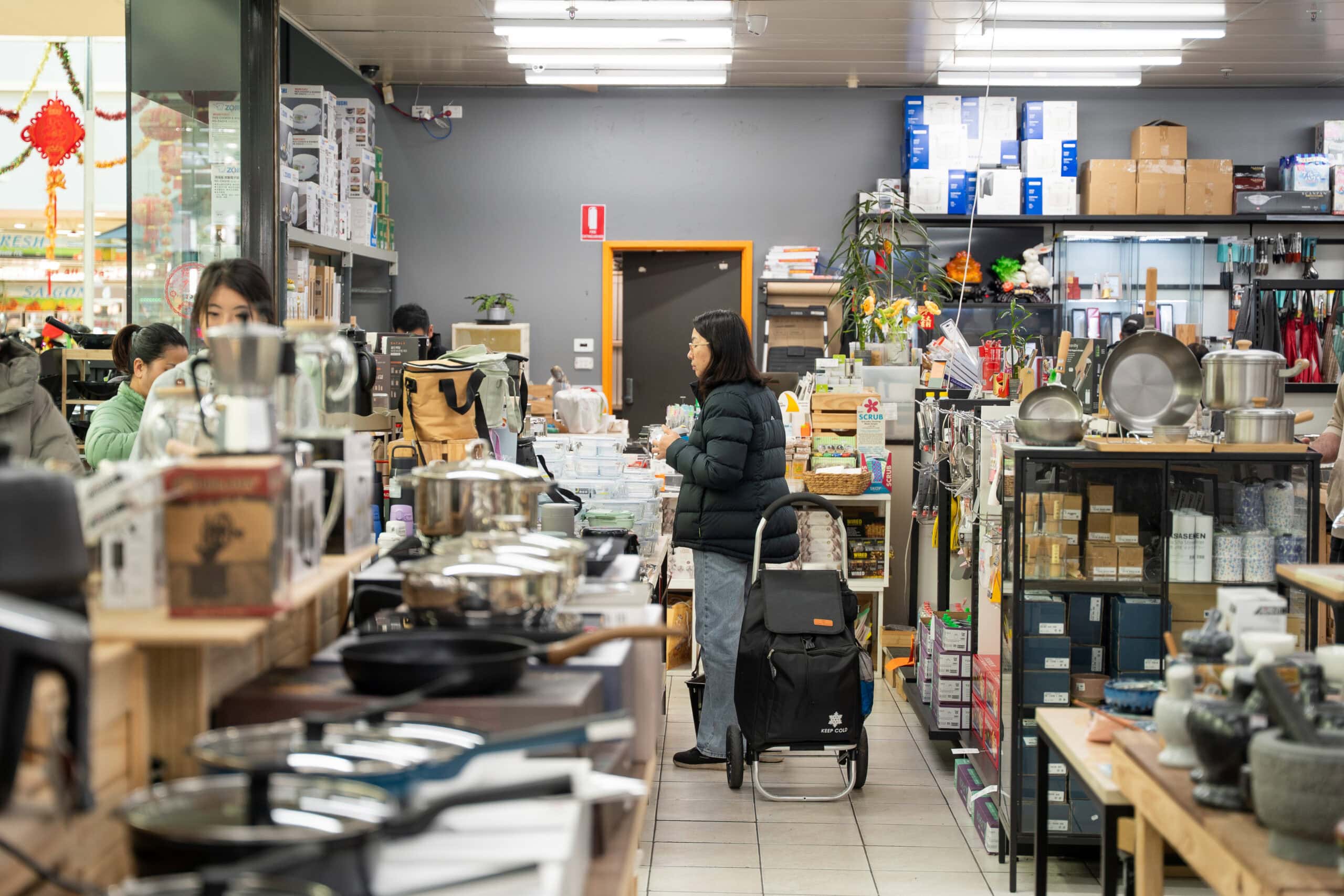 Interior of Grandpa Chen's with cookware, kitchenware and customers shopping.