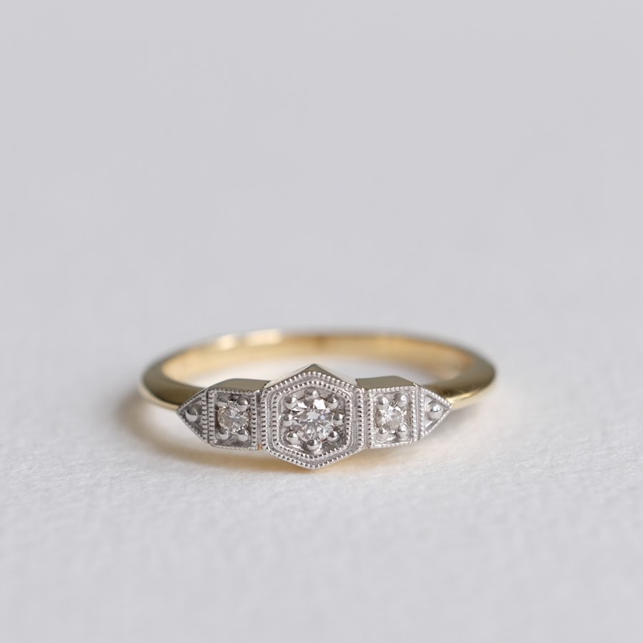 A delicate art deco ring against a white background, created by Paula Walden.