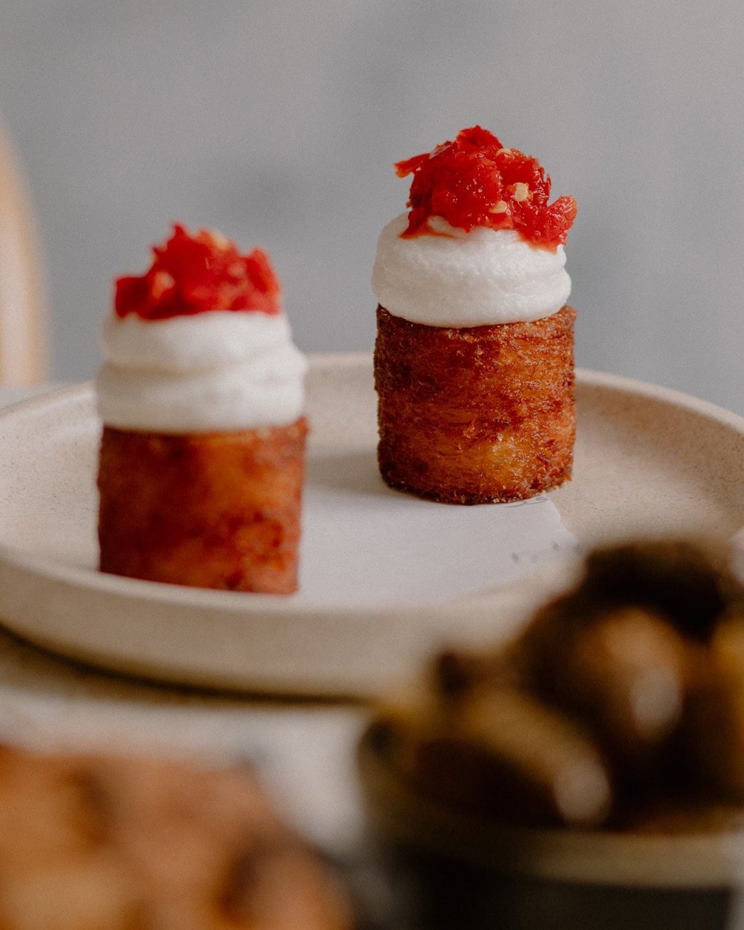 Batata harra fried potato bites topped with whipped toum and fermented chilli at Nour, Surry Hills, Sydney