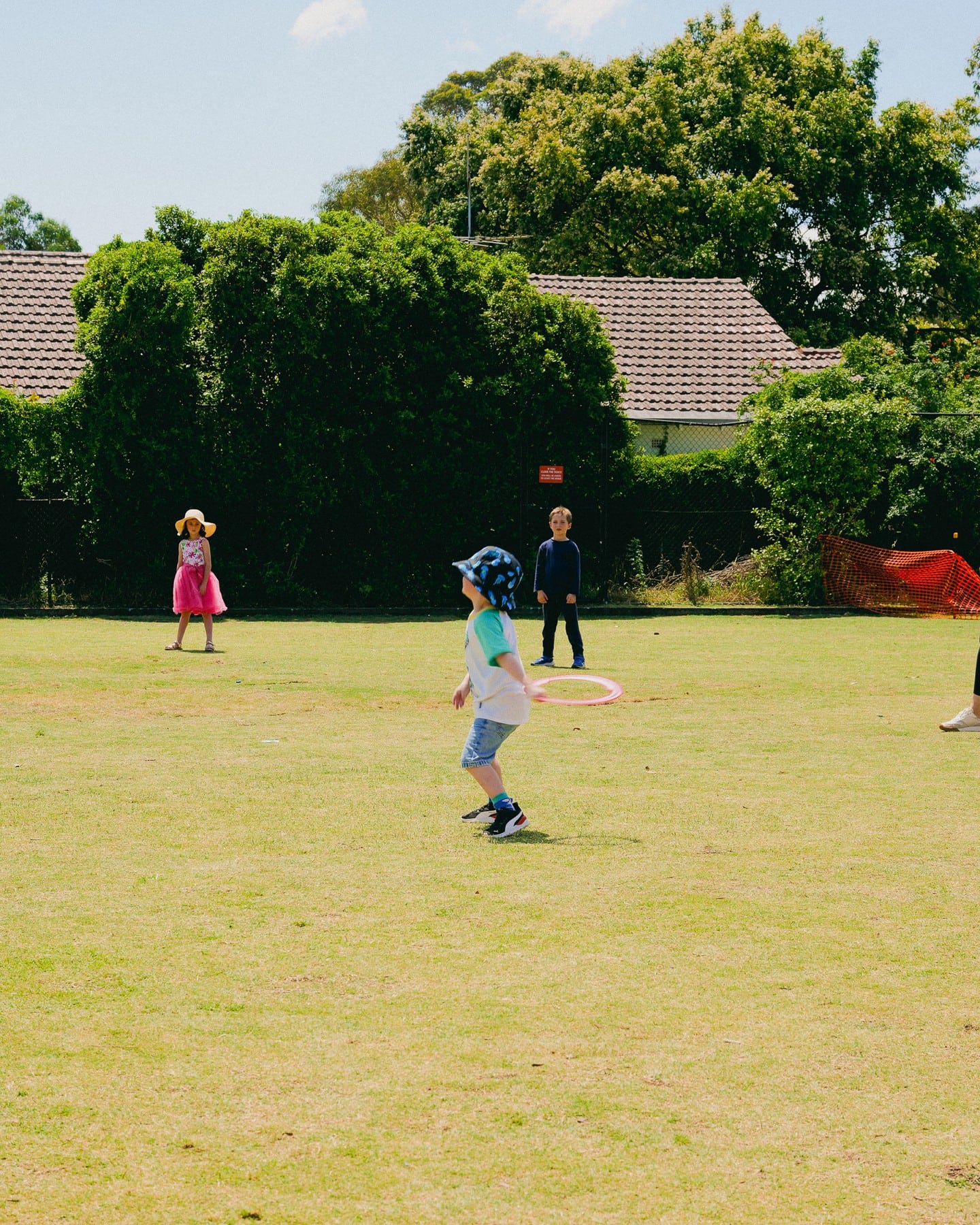 Kids playing on the bowling green at The Diddy in North Sydney.