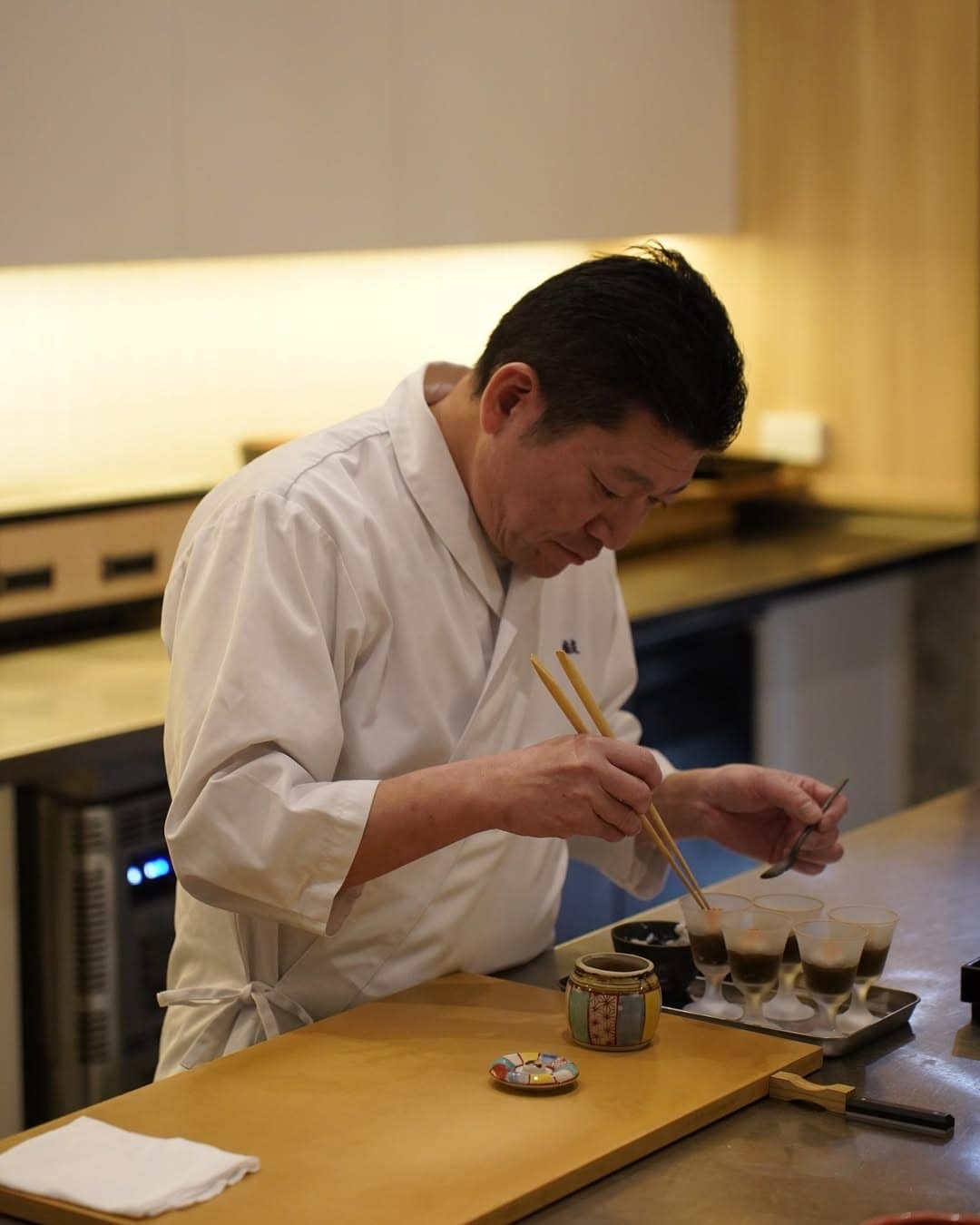 Chef Sun carefully constructing a piece of sushi at Tsuzumi omakase in Barangaroo.