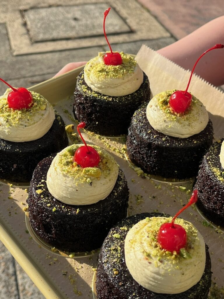 Chocolate pistachio cakes with cherry topping at Little Cocina Bake Shop Collaroy Plateau Sydney