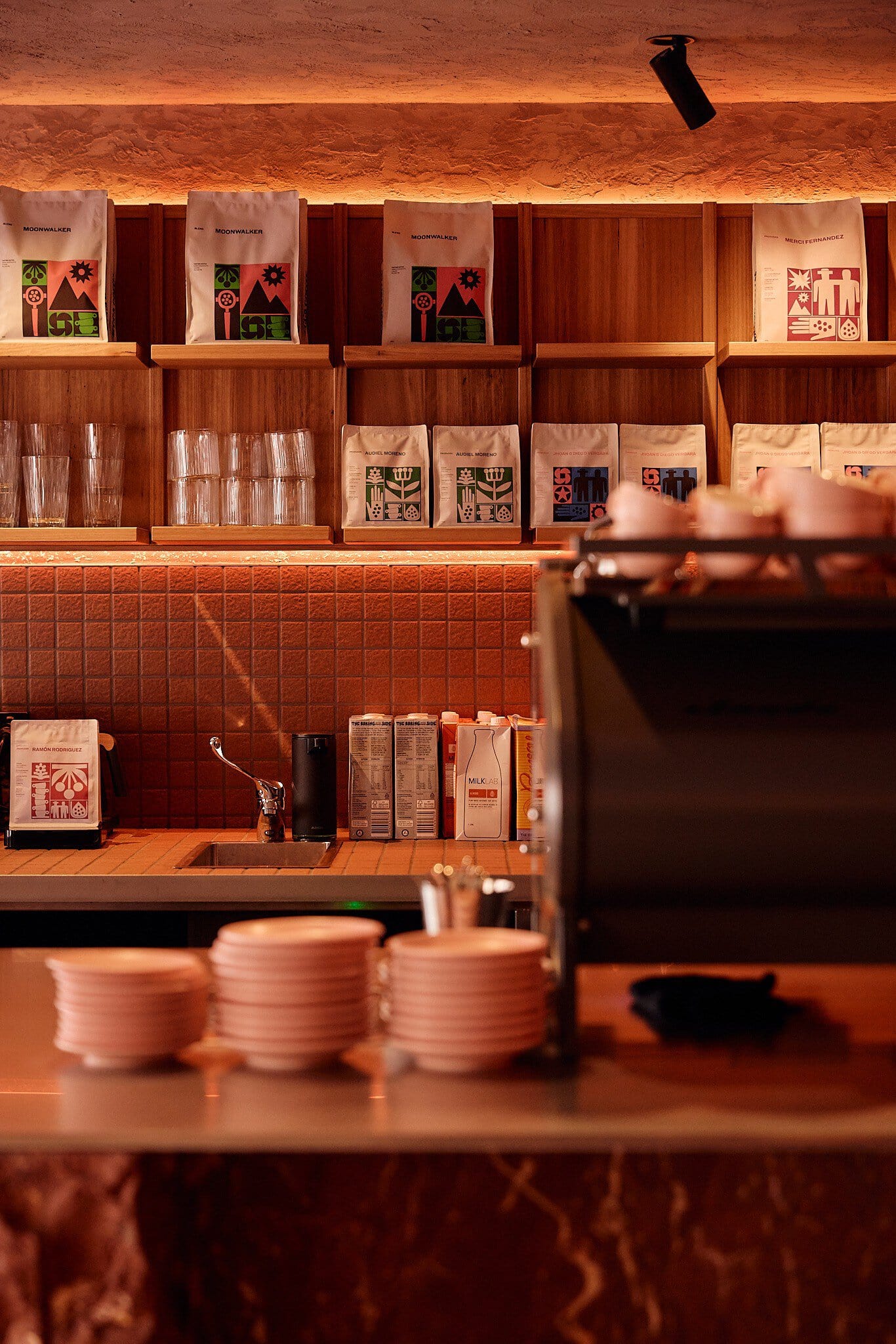 Coffee bags and glassware on shelving at Mecca Coffee Darlinghurst Sydney
