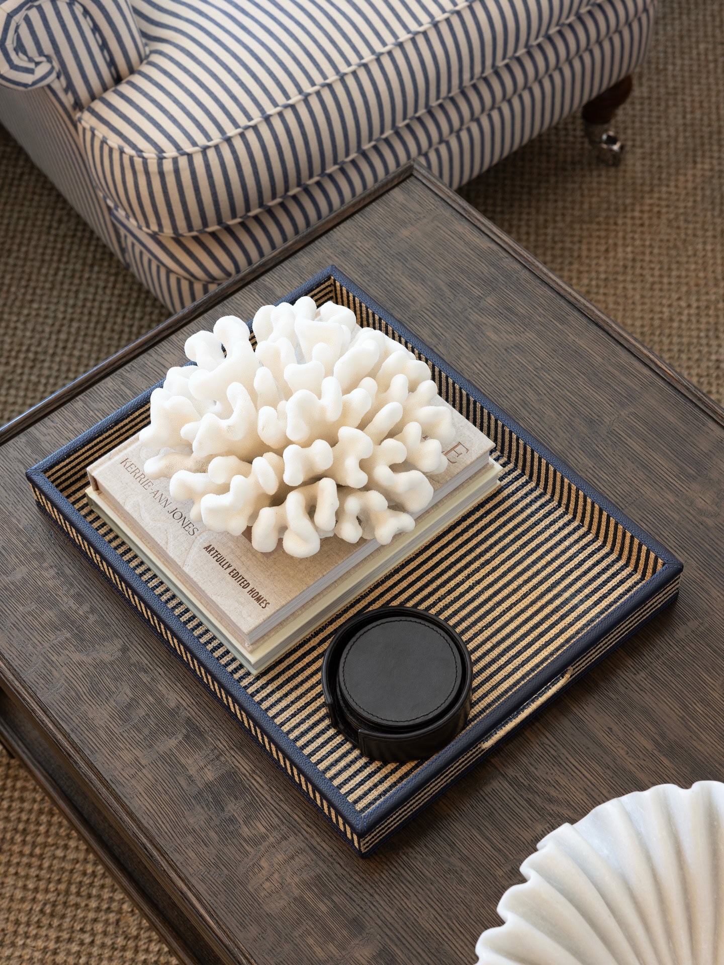 A piece of coral sitting atop some books on a coffee table at Highgate House in Albion.