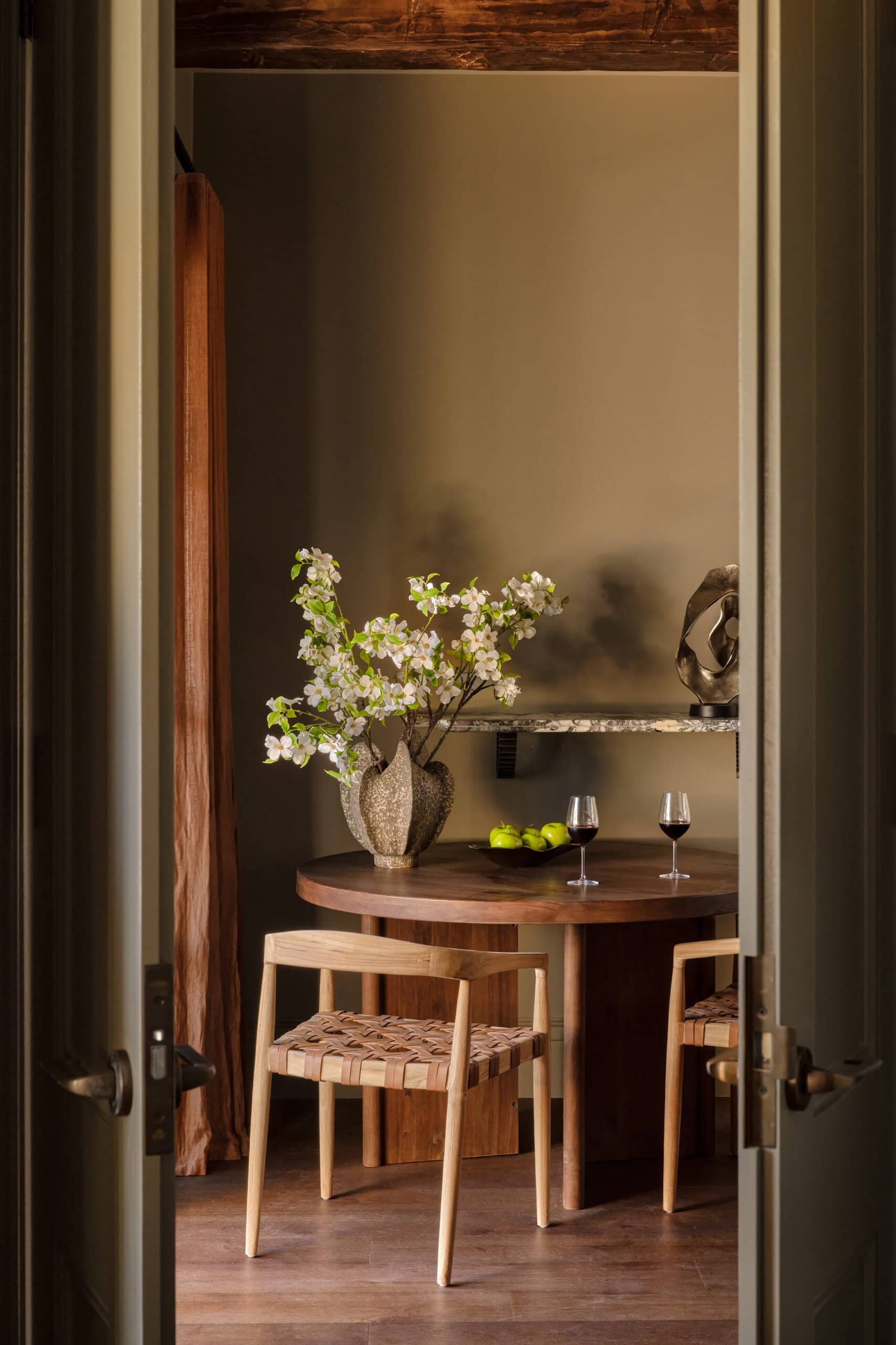 Villa dining nook with wine at The Grand Saddles Lodge Mount White NSW