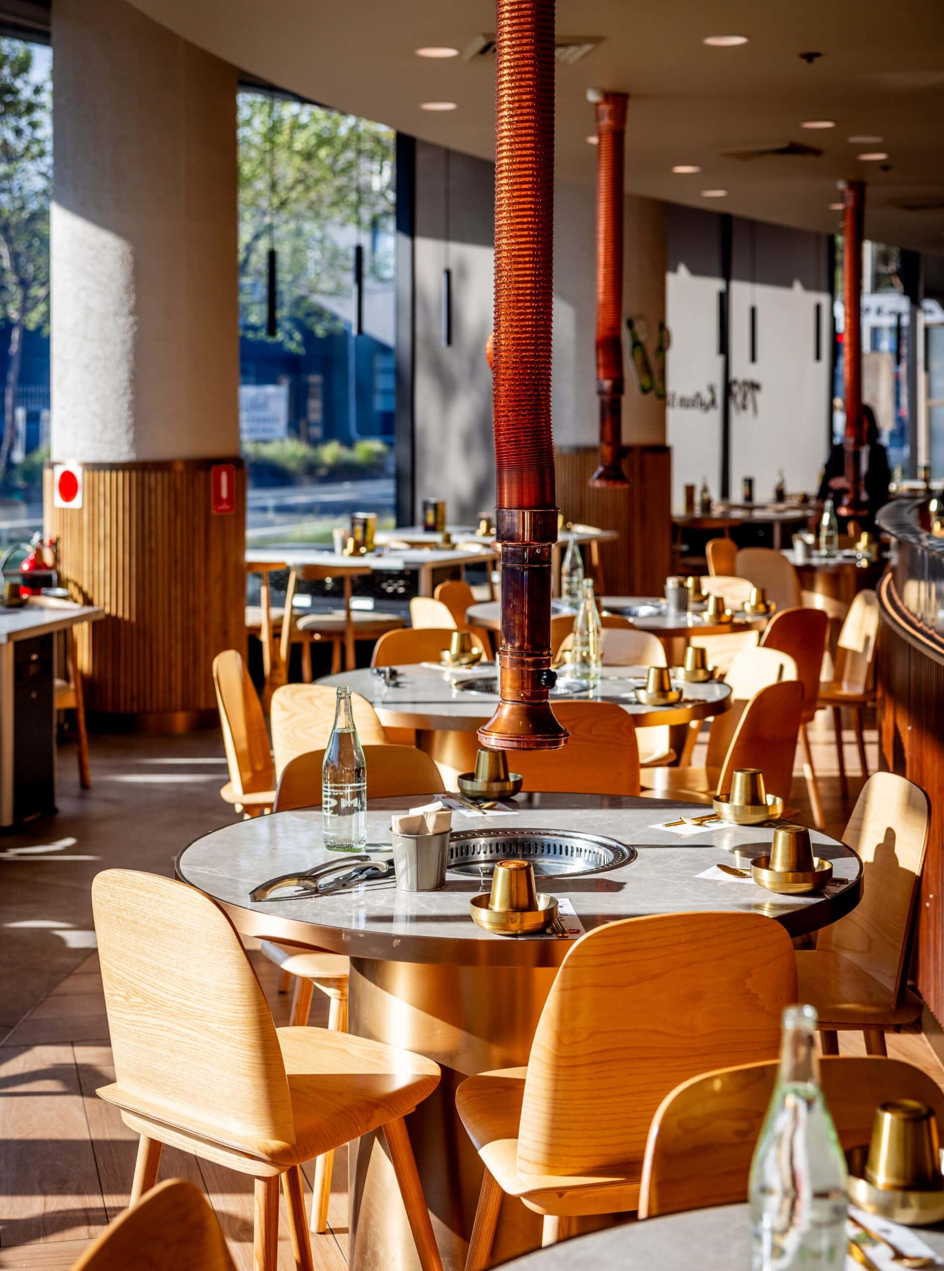 The dining room at 789 Korean BBQ in Darling Square, featuring individual grill tables.