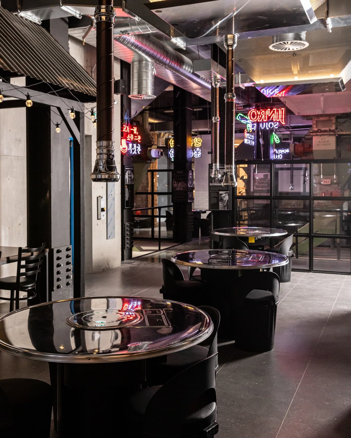 The futuristic dining room at Hongdae Pocha in Chippendale, featuring individual grill tables.