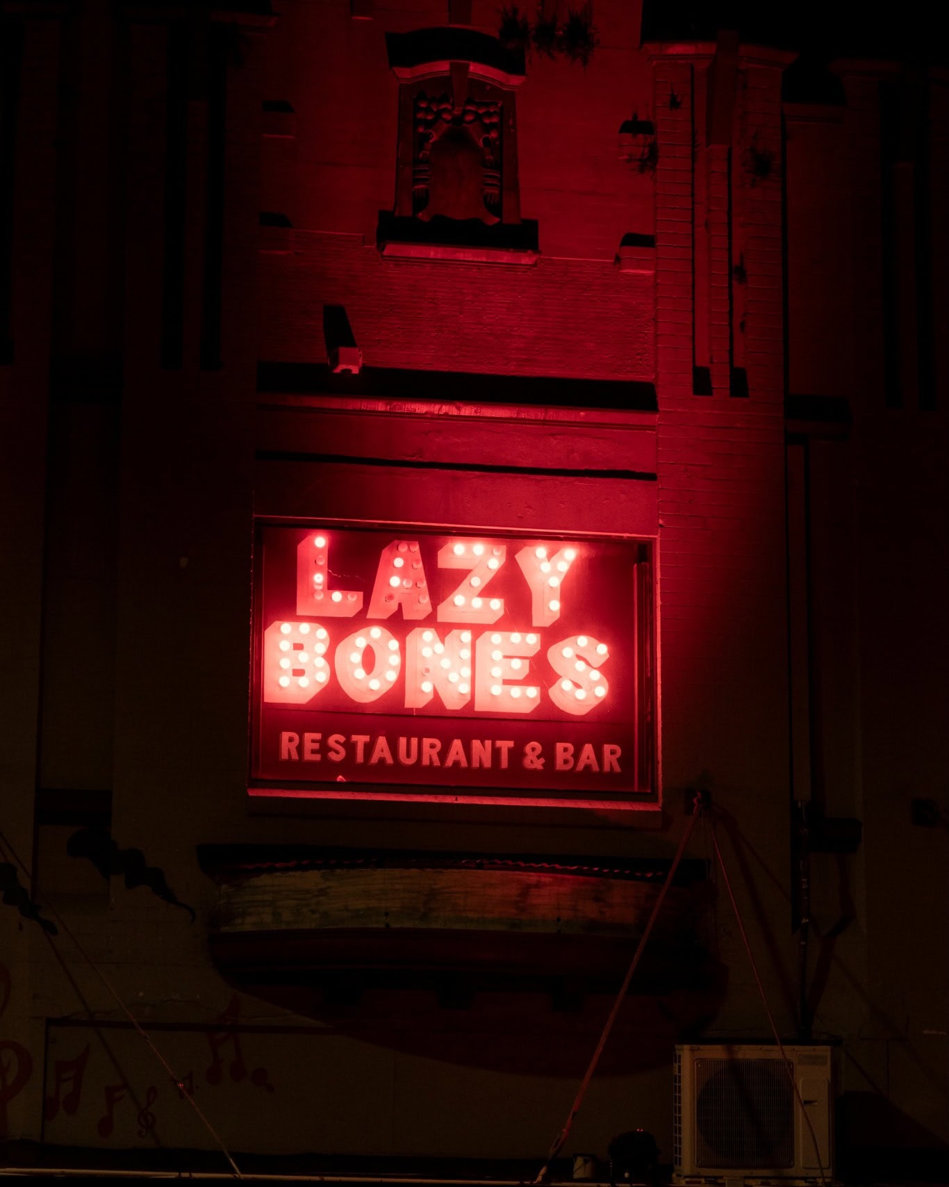 A red neon sign out the front of Lazy Bones Lounge & Bar in Marrickville.