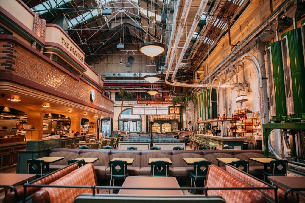 Roastery and cafe interior with overhead coffee bean pipes at The Grounds Coffee Factory South Eveleigh Sydney