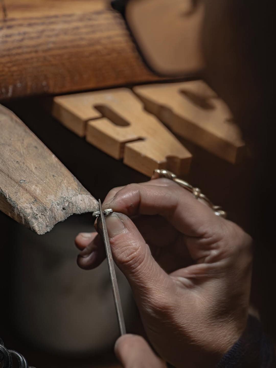An artisan jewellery maker using tools to work on a ring at Paula Walden.