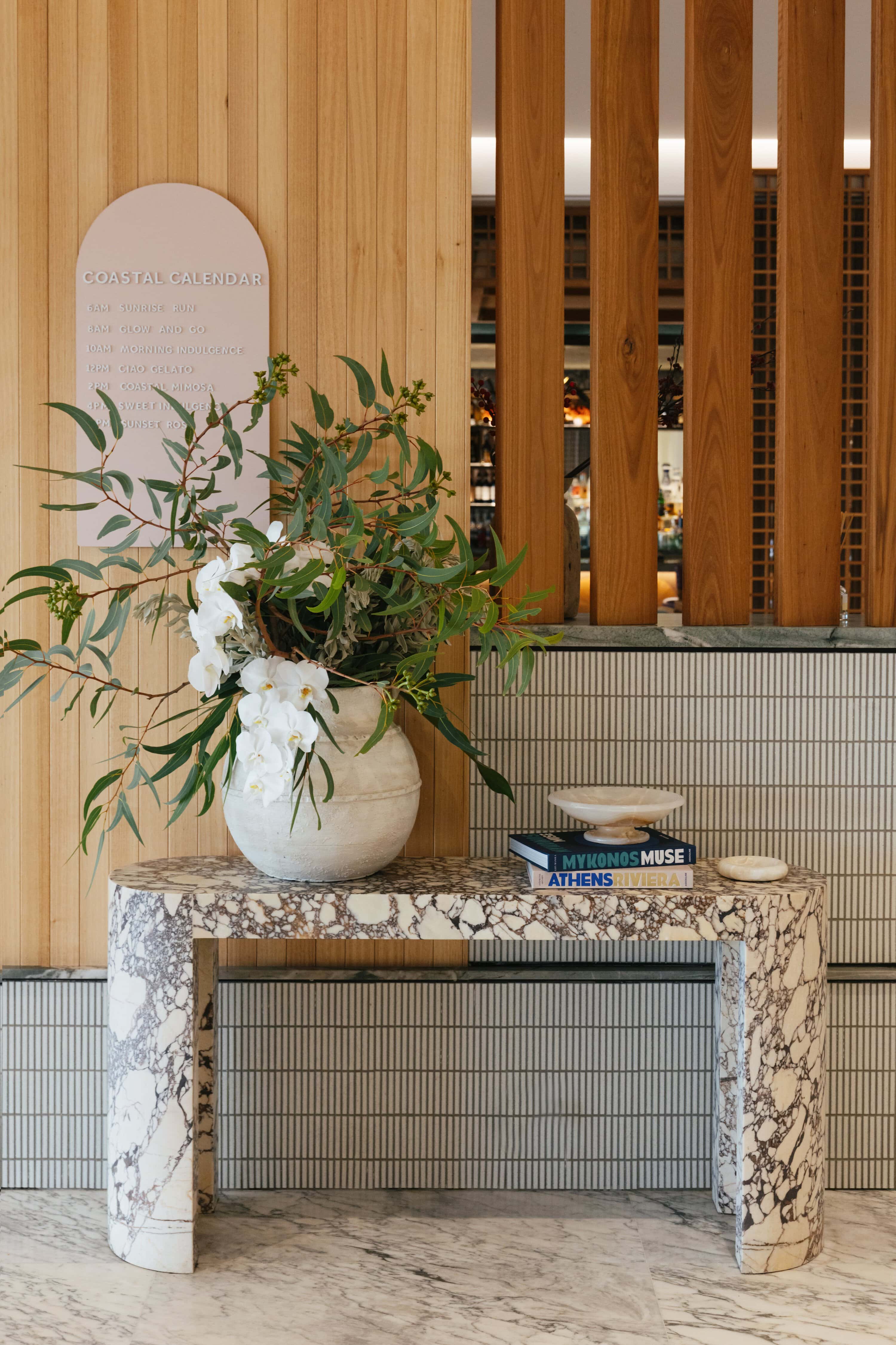 Lobby console with floral arrangement at Elysium Manly