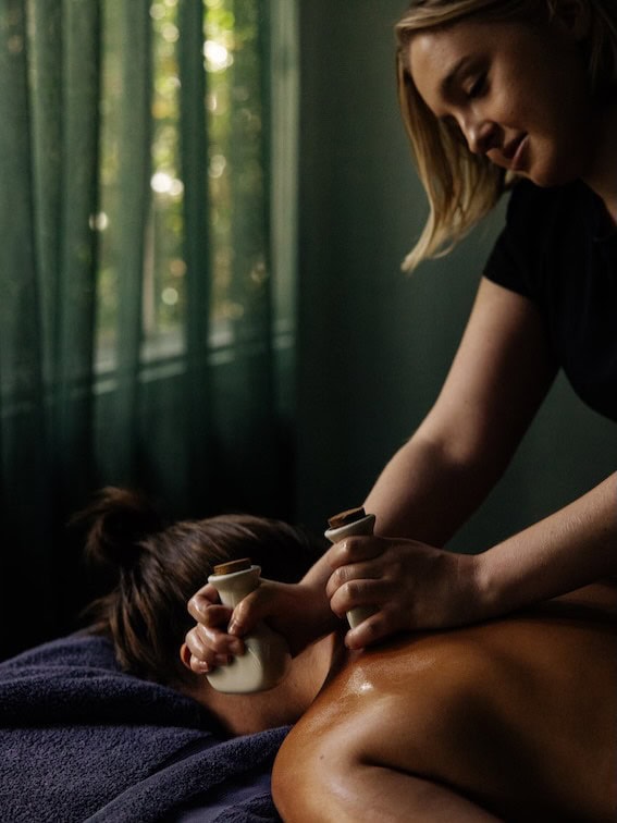 A woman receiving a massage via stone tools at Osborn House in the Southern Highlands.