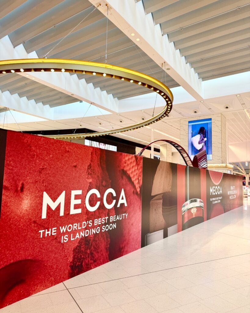 MECCA construction hoarding announcing new airport store at Sydney Airport T1