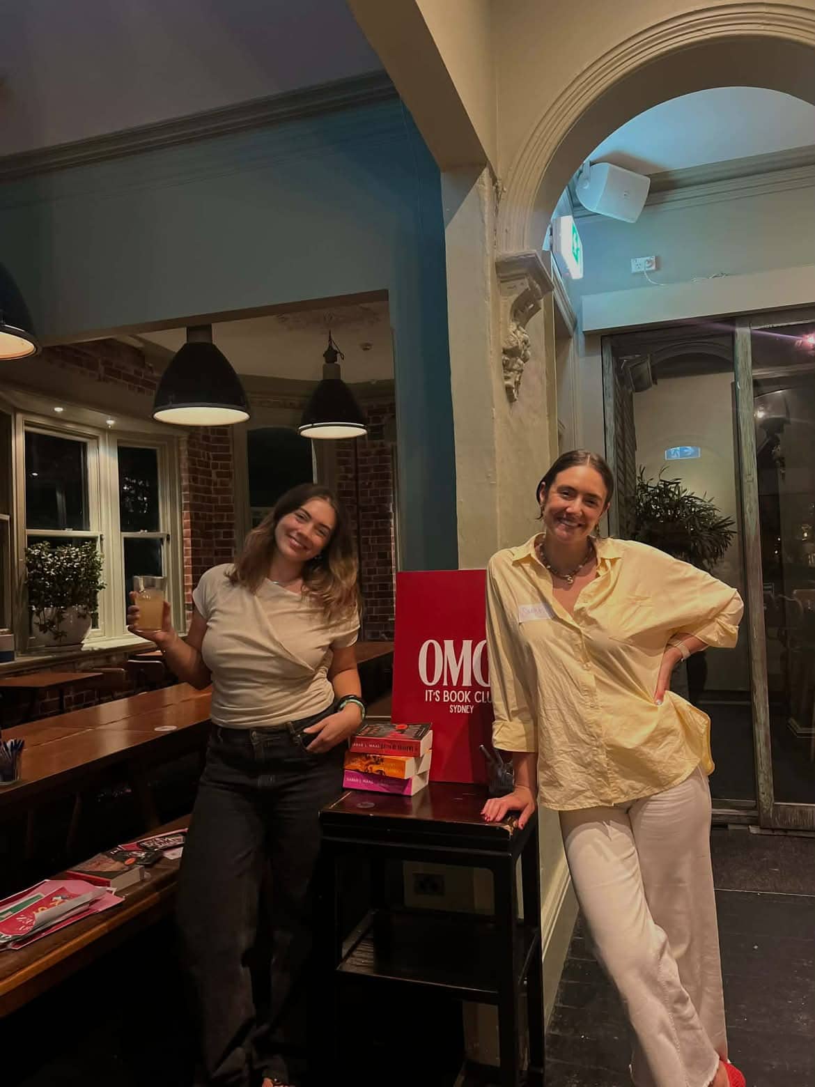 OMG! It's Book Club members posing with signage and stack of books