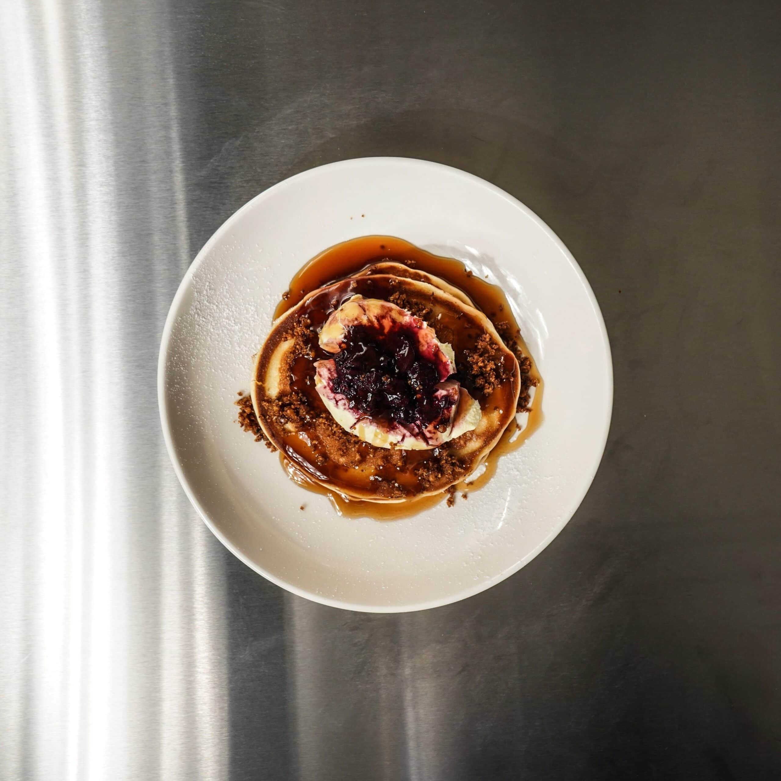 Pancakes with berry compote and maple syrup at The Naked Baker Marrickville Sydney