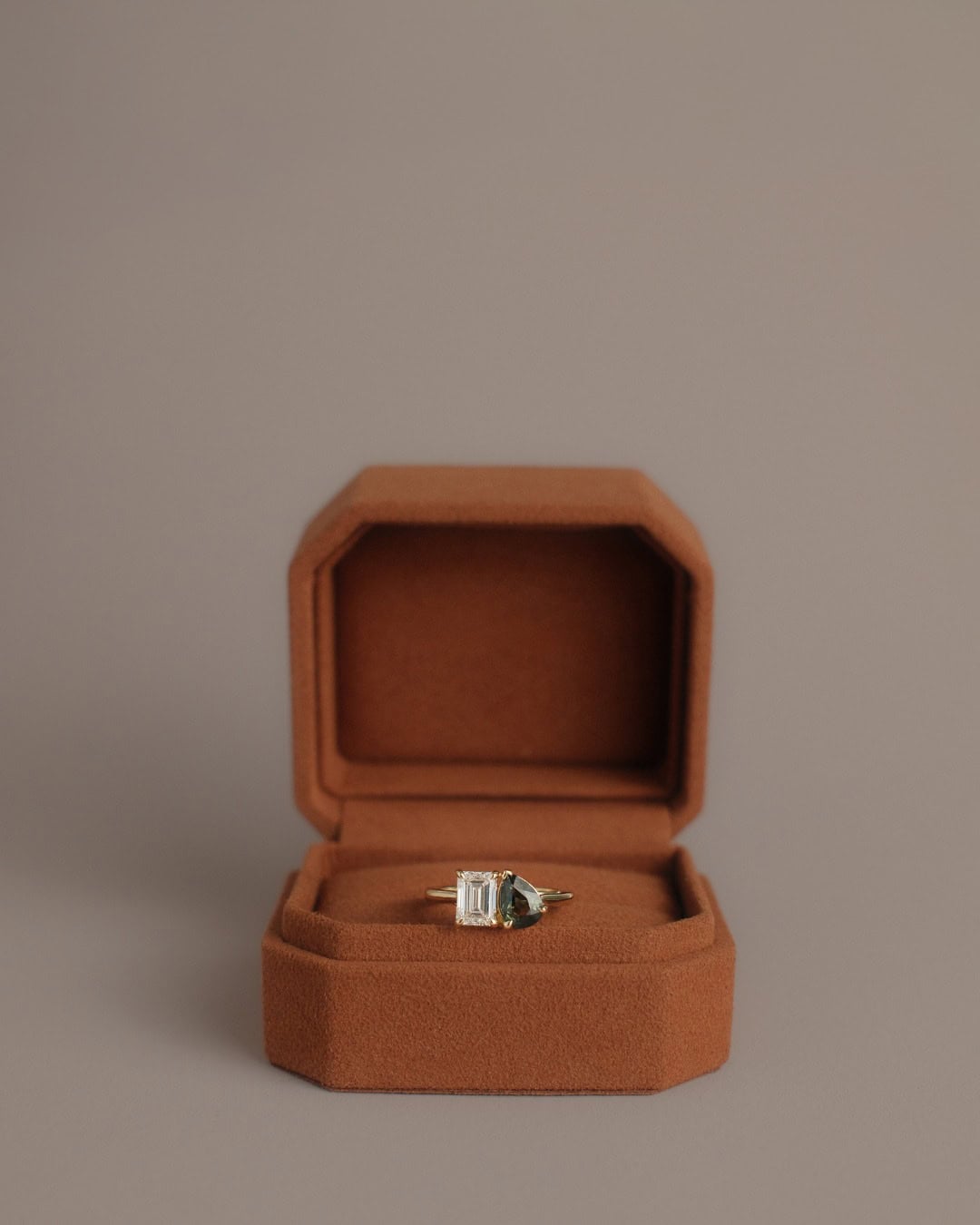 A diamond ring in a burnt orange box from Molten Store.