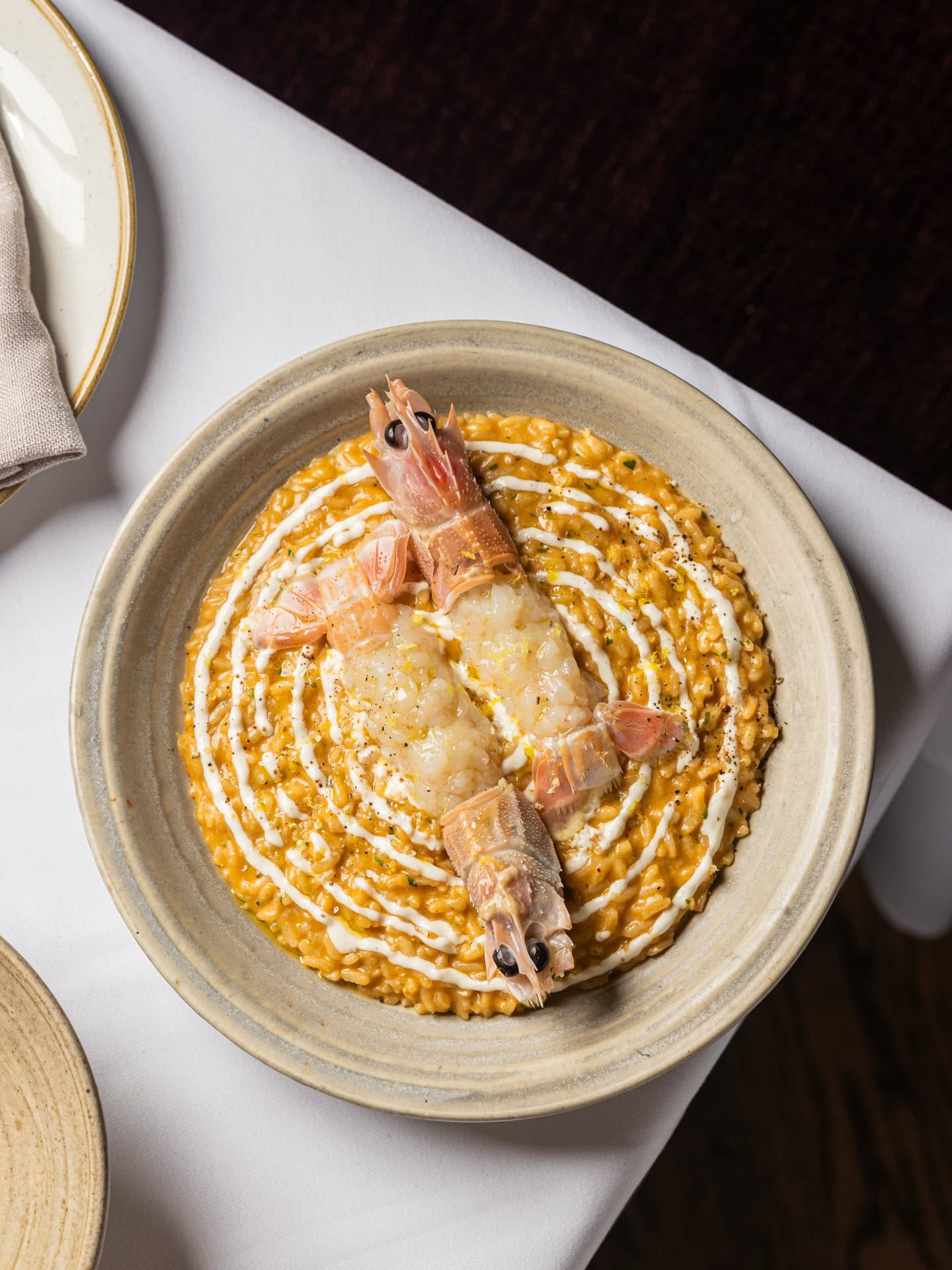 A plate of risotto with a scampi on top at Conte in Sydney.