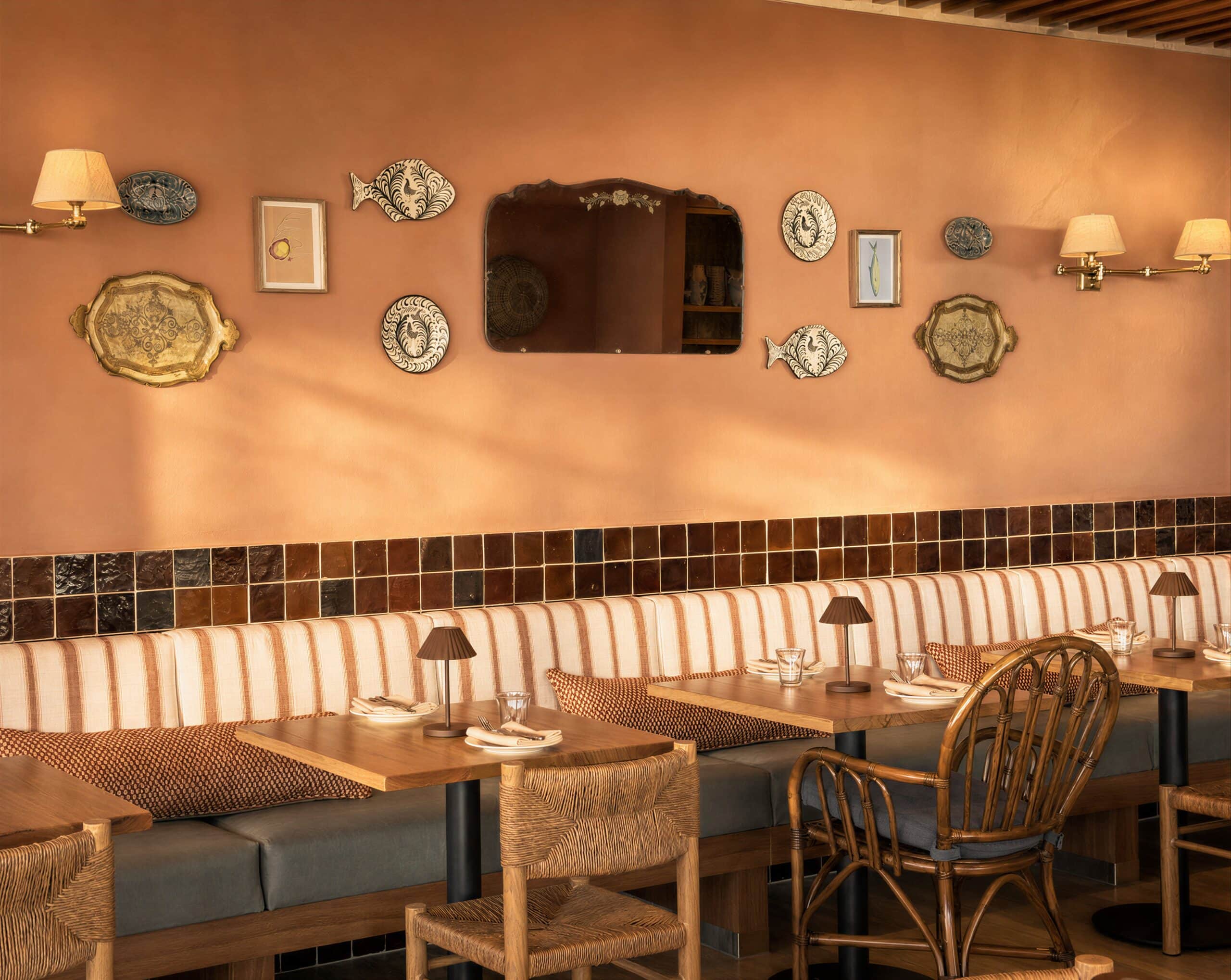 A curated dining room featuring striped banquette seating at Valentina in Surfers Paradise.