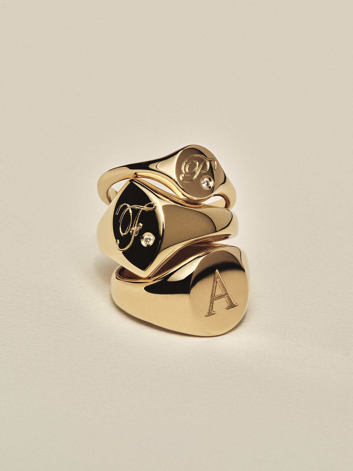 A stack of Natasha Schweitzer signet rings.