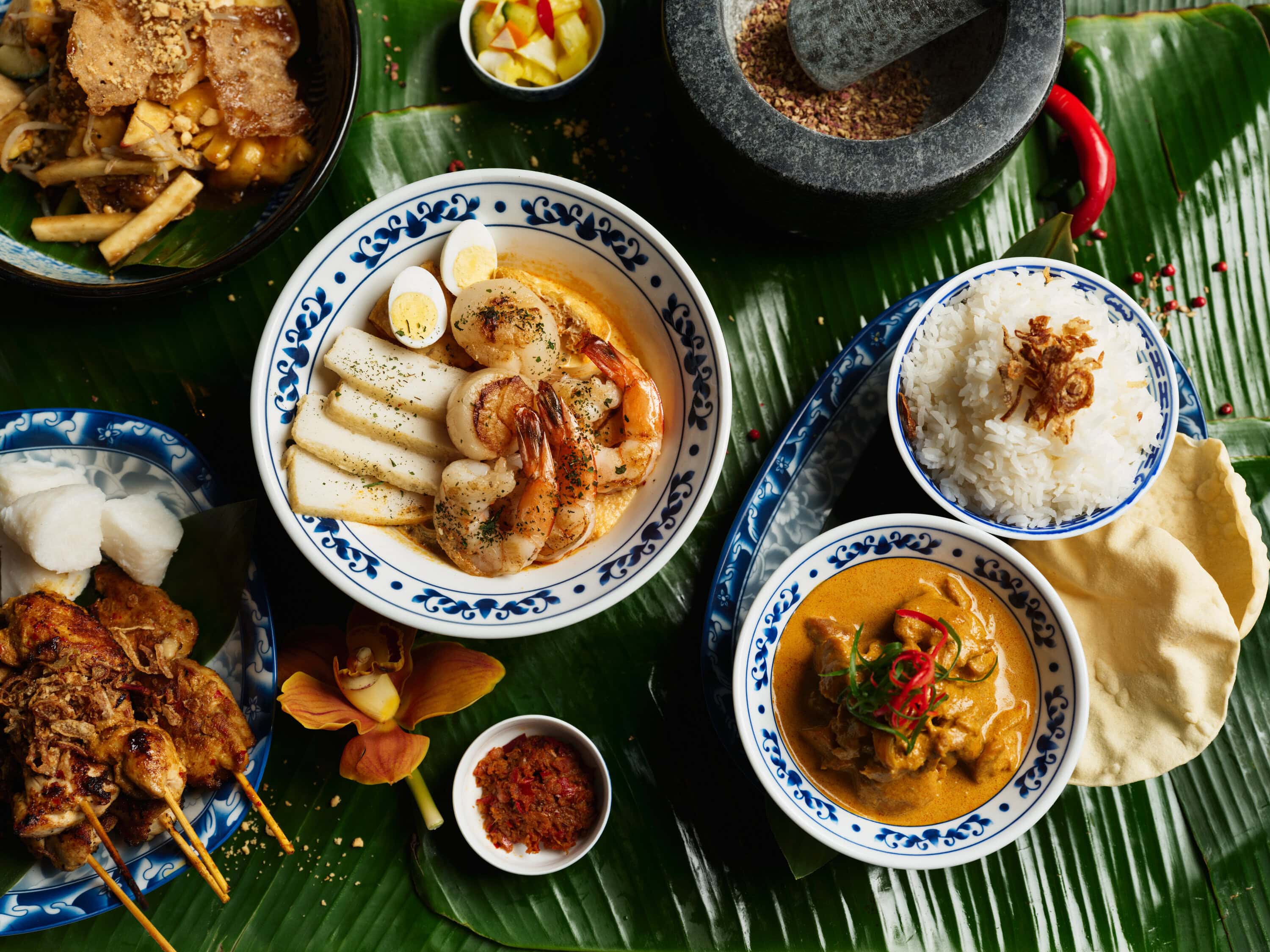 Singapore hawker-style laksa, satay chicken and char kway teow spread at The Fullerton Hotel Sydney CBD