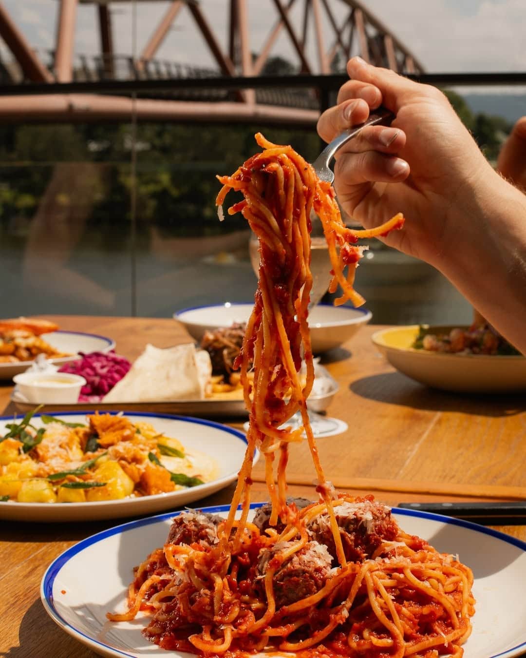 Someone using a fork to pick up spaghetti from a plate at The Log Cabin in Penrith.
