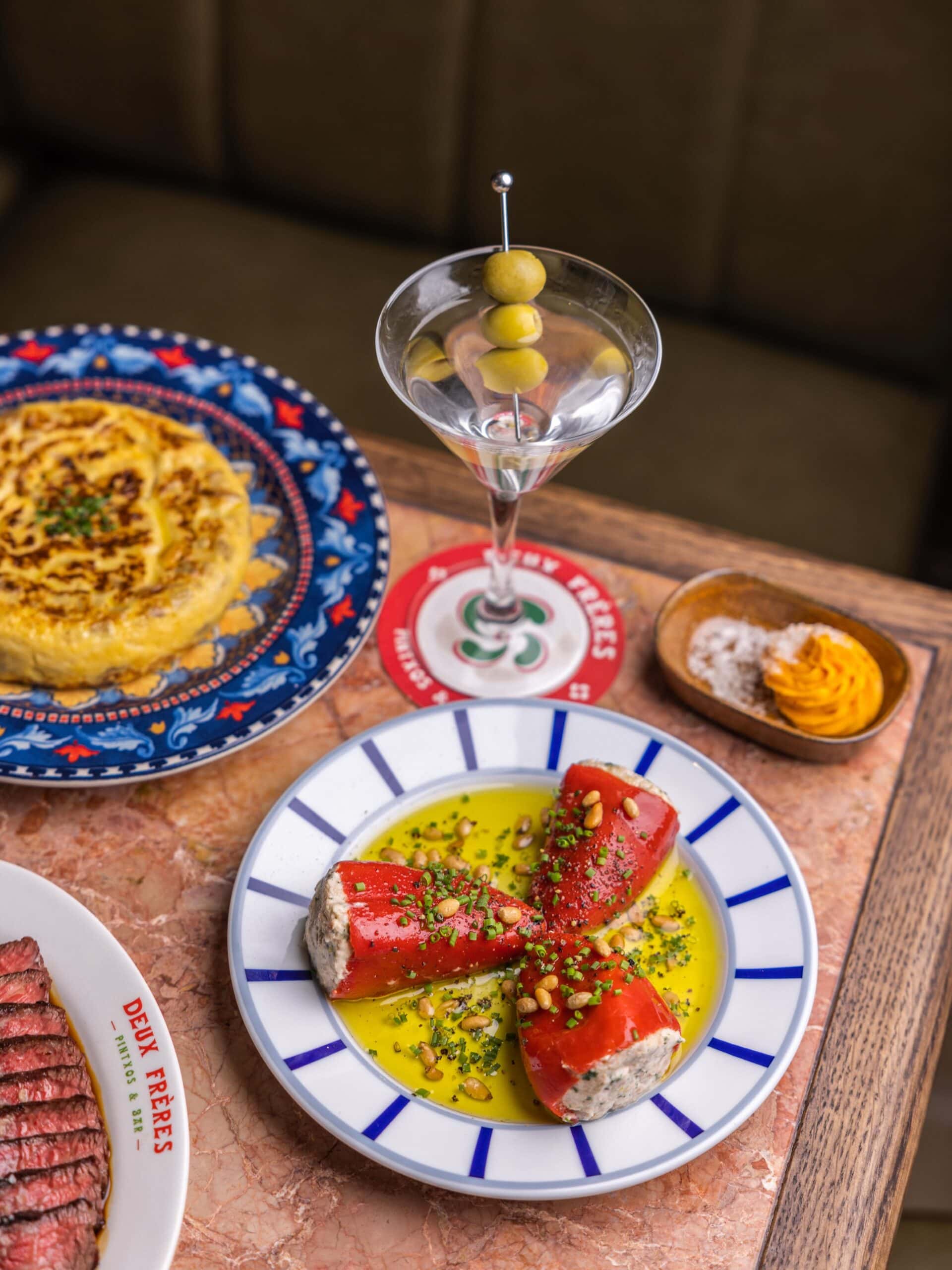 A martini, stuffed peppers and tortilla atop colourful plates at Deux Ferres in Circular Quay.