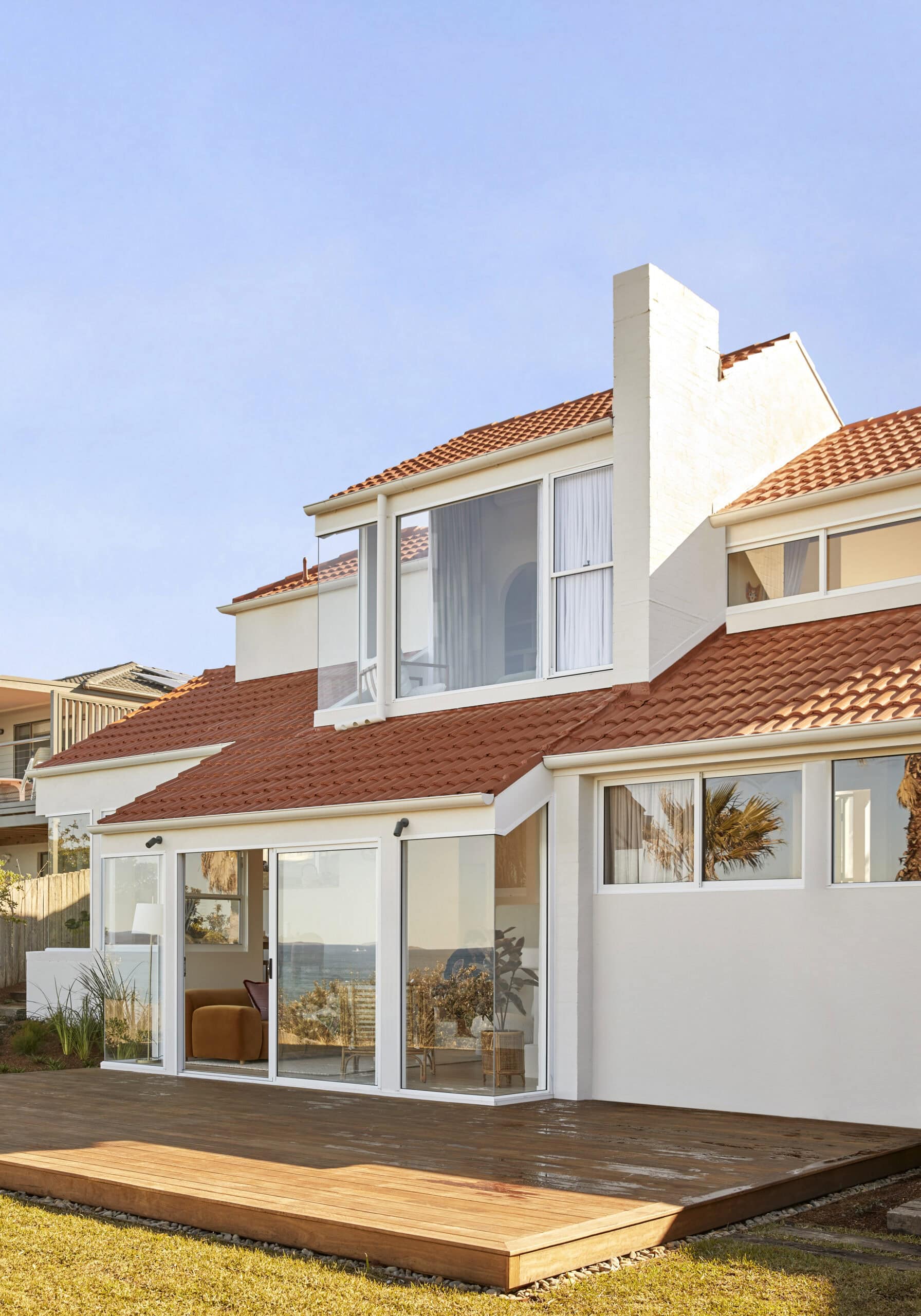 The orange and white exterior of two storey holiday home Chante Mer in Mollymook.
