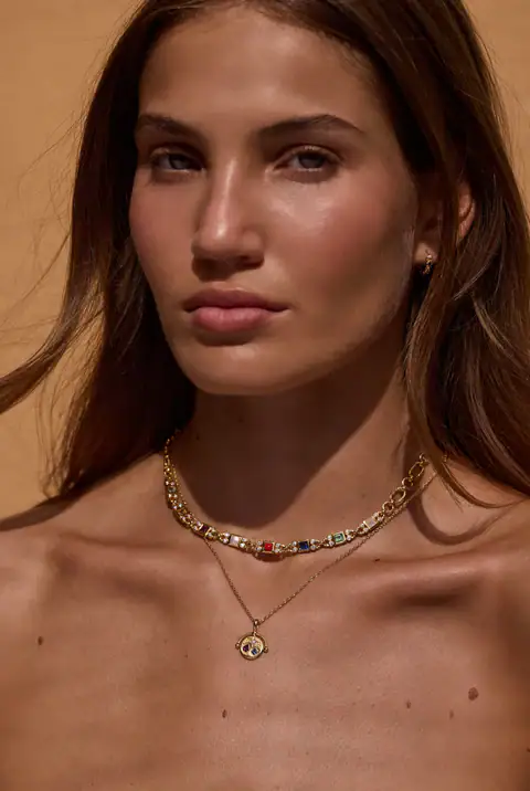 Model wearing Tonimay necklace stack, colourful gold auralis necklace and aster gold necklace