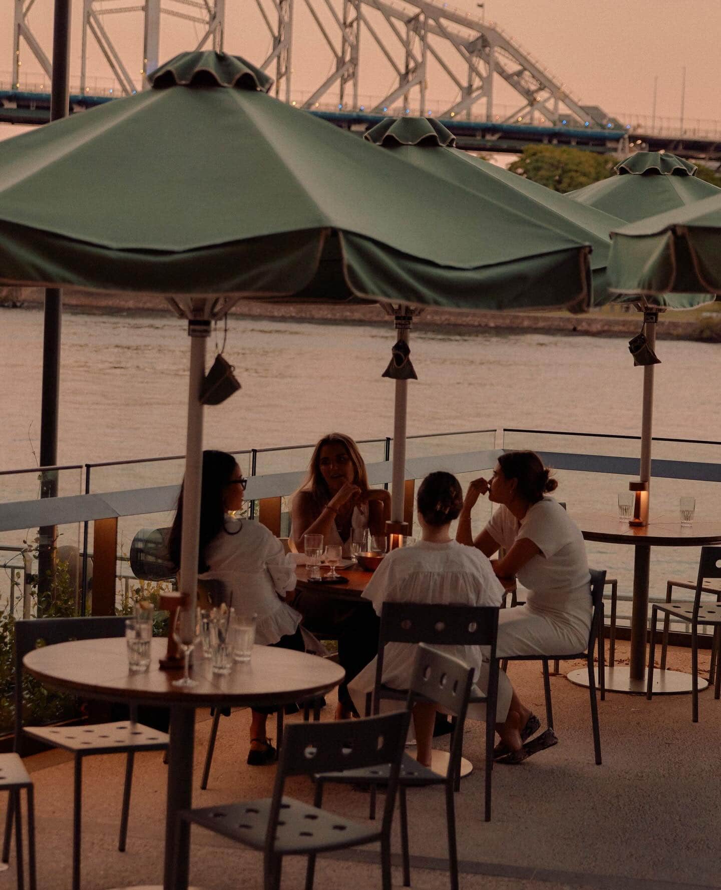 The alfresco dining area at Supernormal at dusk with views of the Story Bridge.