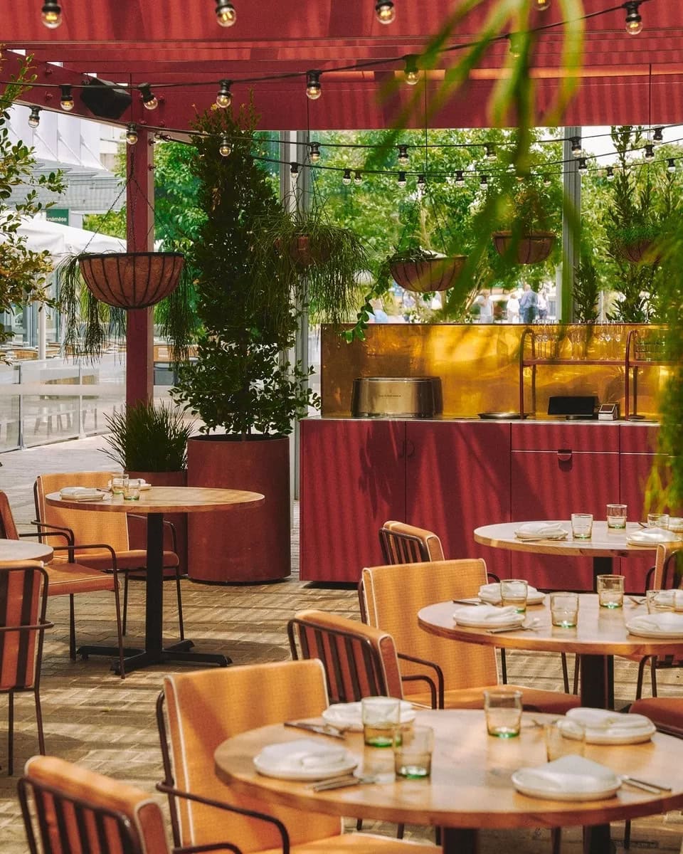 The alfresco dining area at Watermans in Barangaroo featuring a maroon, cream and wood colour palette.
