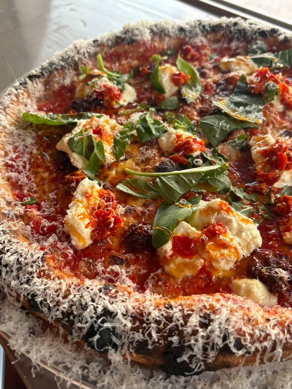 Wood-fired pizza with burrata, chilli oil and basil at Pizza Laundry Sydney CBD