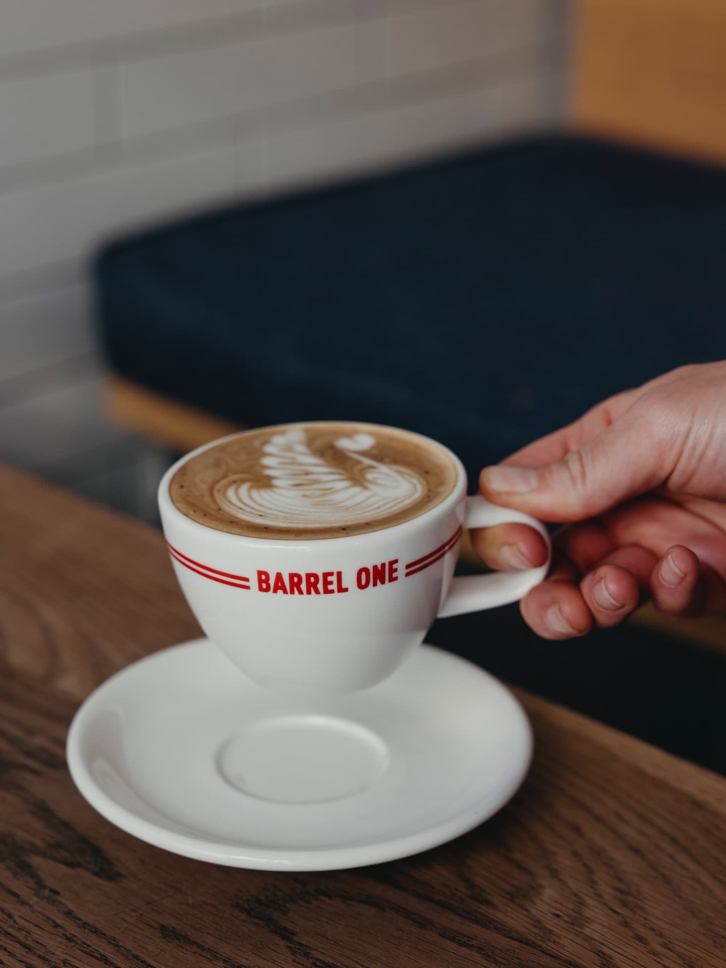 Coffee with latte art in Barrel One branded cup at Barrel One Potts Point Sydney