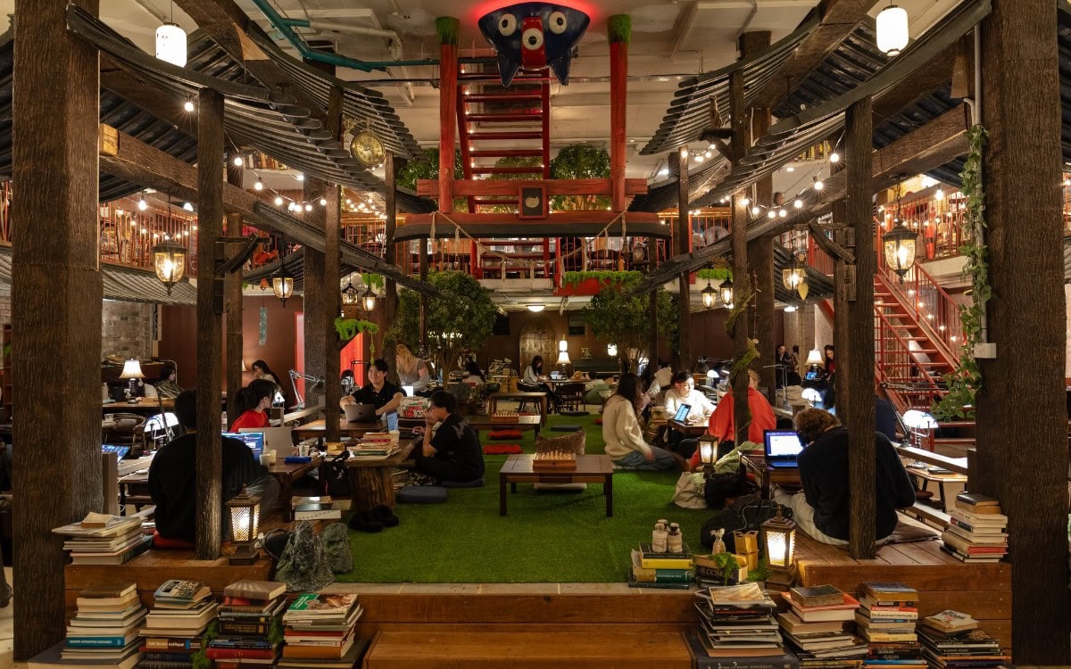 Ghibli-inspired coworking lounge with wooden beams and books at 03 Space Newtown Sydney