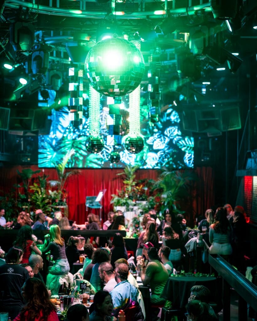Crowd gathered under green disco ball at Bingo Botanica event Darlinghurst Sydney