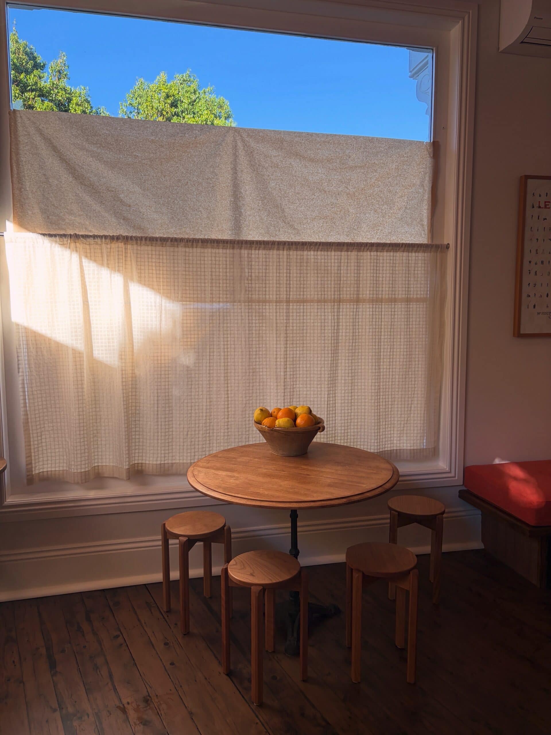 A round wooden table in the corner of the dining room at Adelaide's Kitchen in Paddington.