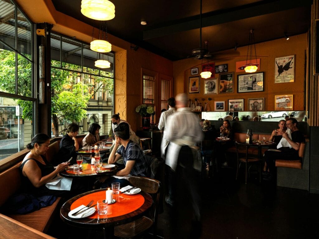 Restaurant dining room with vintage pendant lighting and booth seating at Pellegrino 2000 Surry Hills Sydney