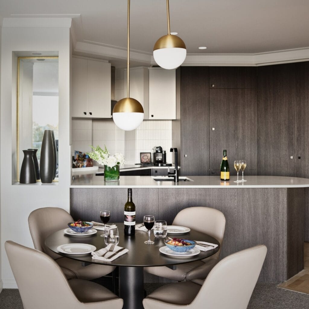 The dining room and kitchen in one of the self service suites at Pullman Quay Grand Sydney Harbour.