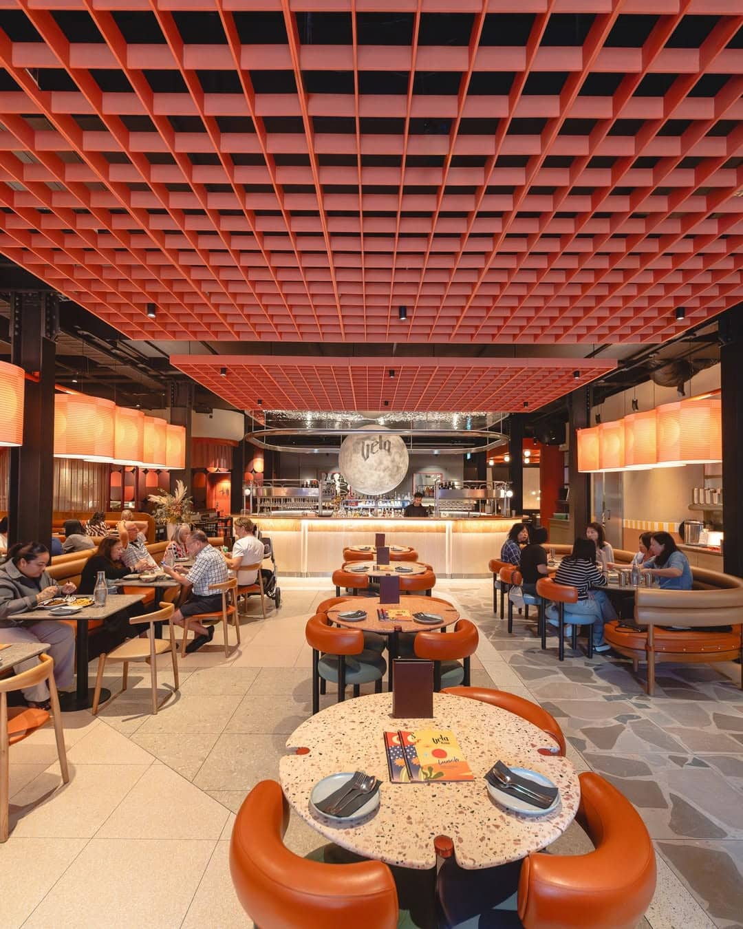 The autumnal tone dining room of Vela in Brisbane.