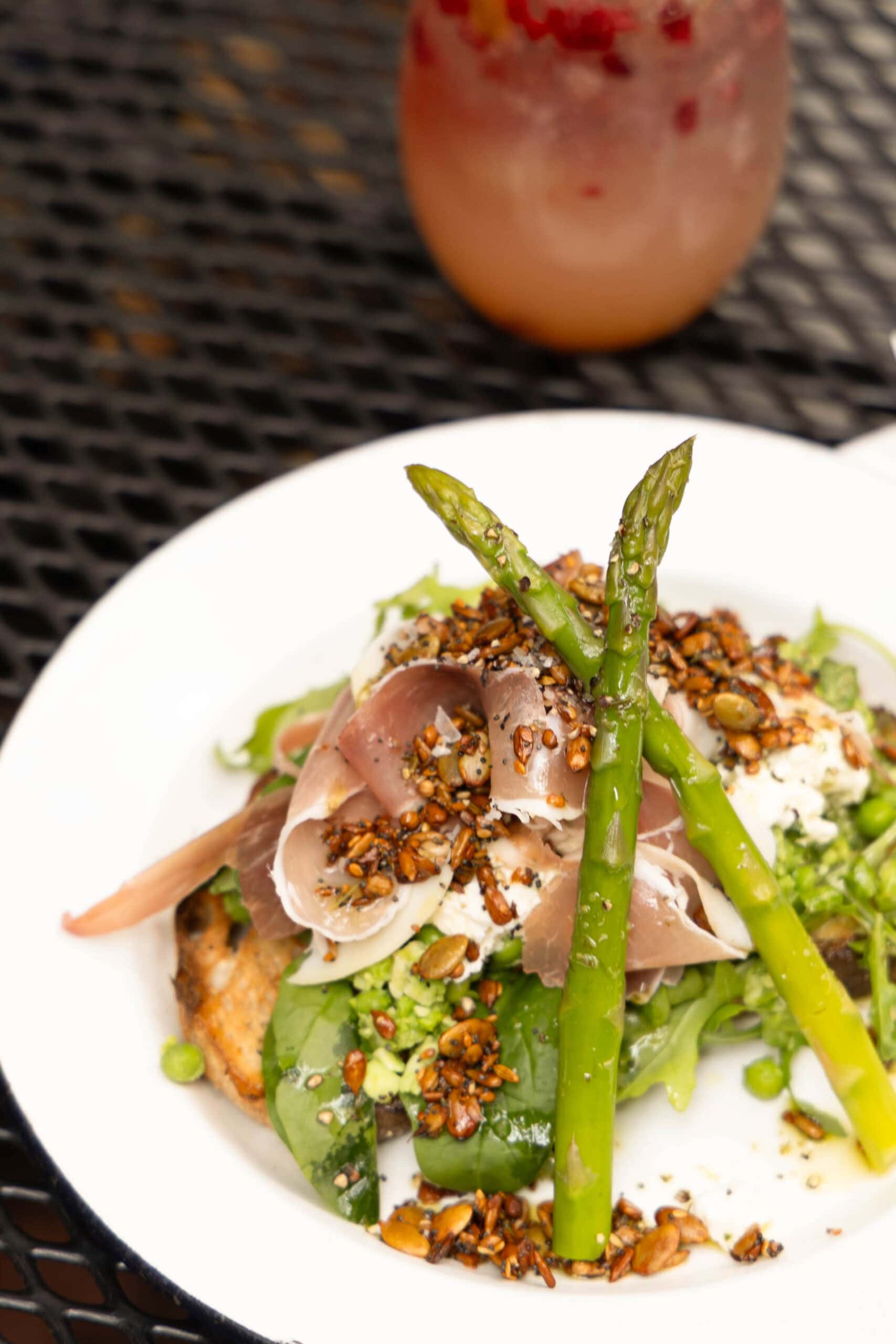 A plate of eggs topped with asparagus at Alby + Esthers in Mudgee.